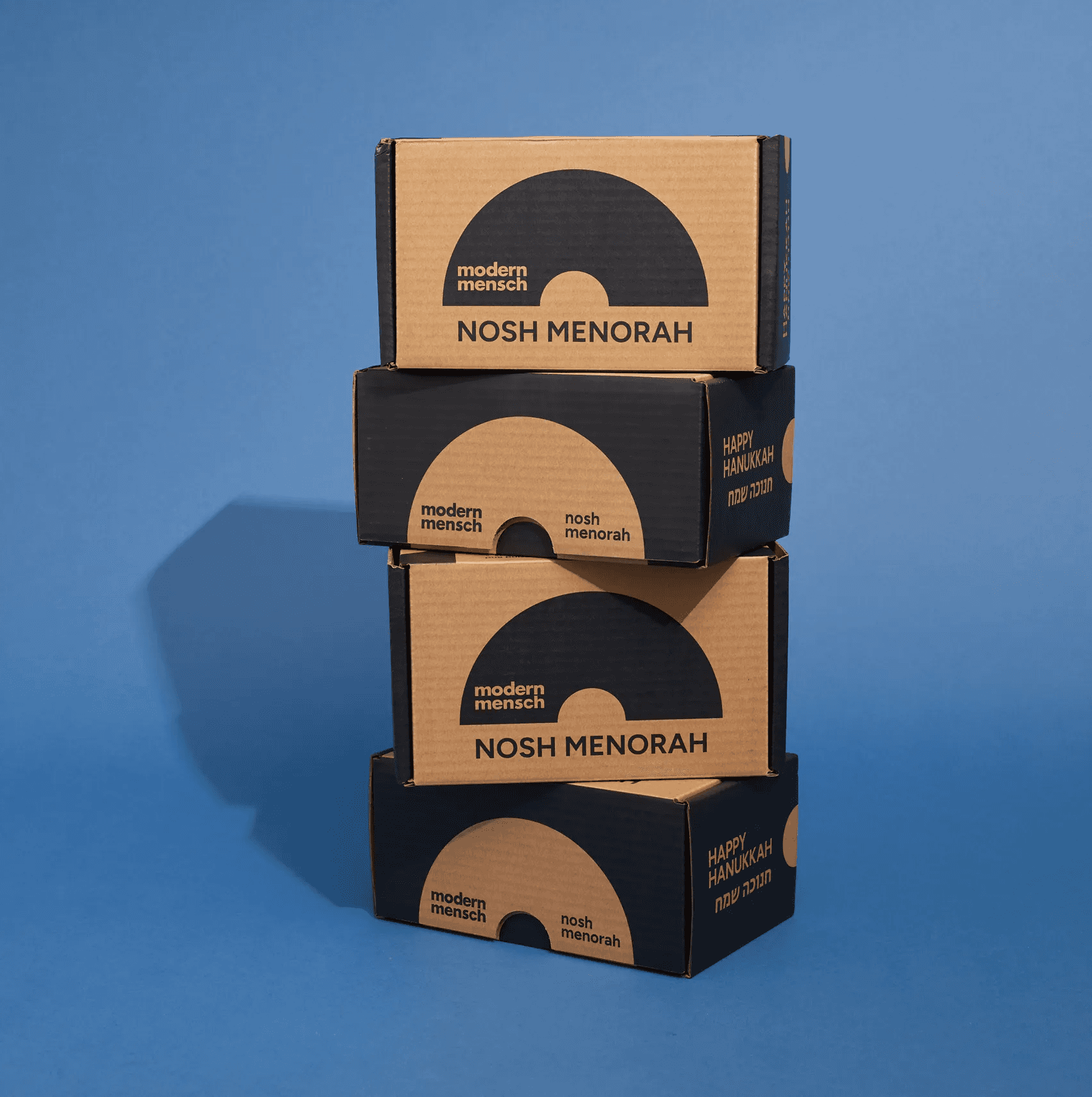 Four Modern Mensch Nosh Menorah packages stacked vertically on a blue background
