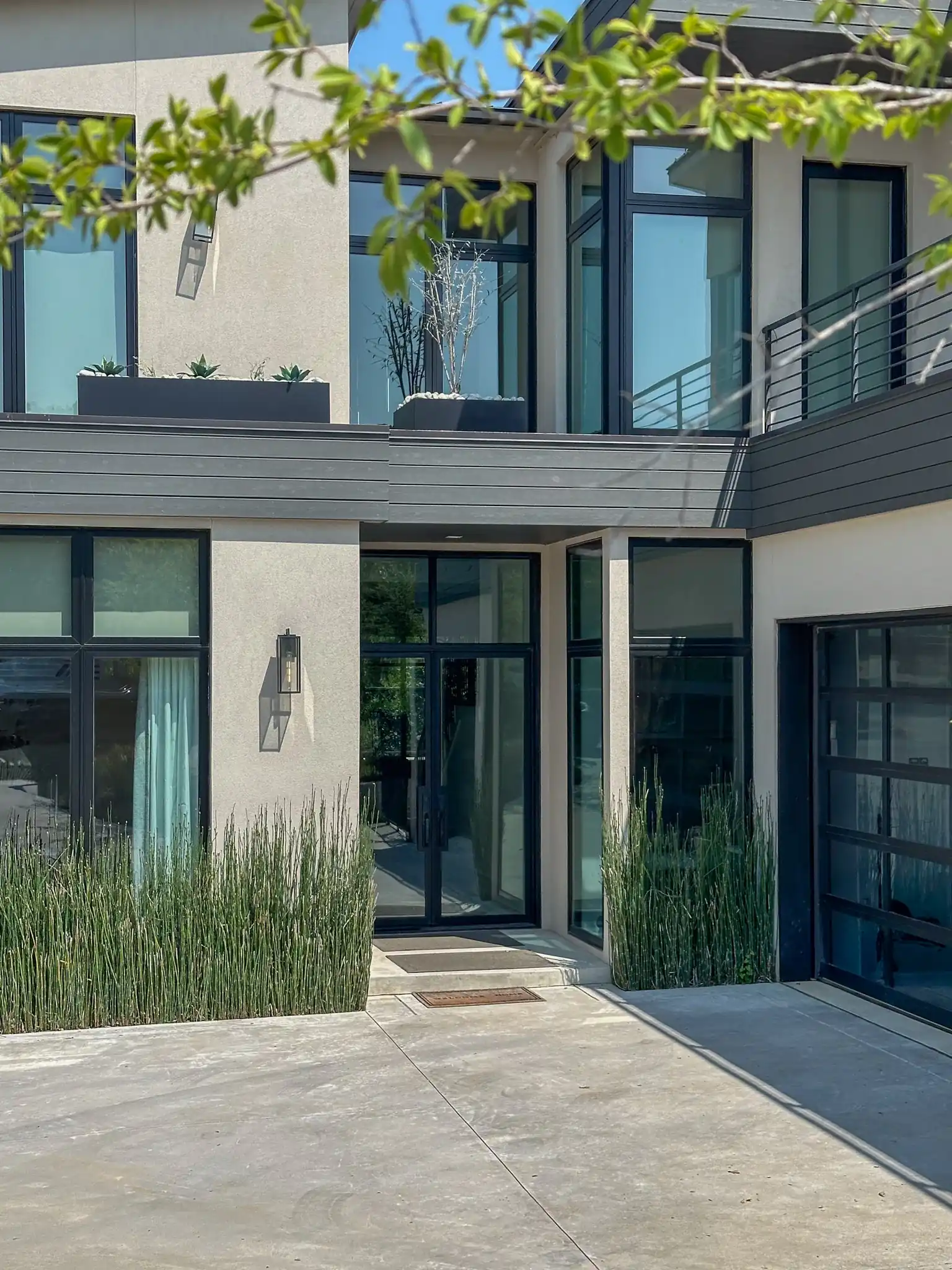 Modern low profile iron door with side lite and transom installed on a Dallas-Fort Worth home