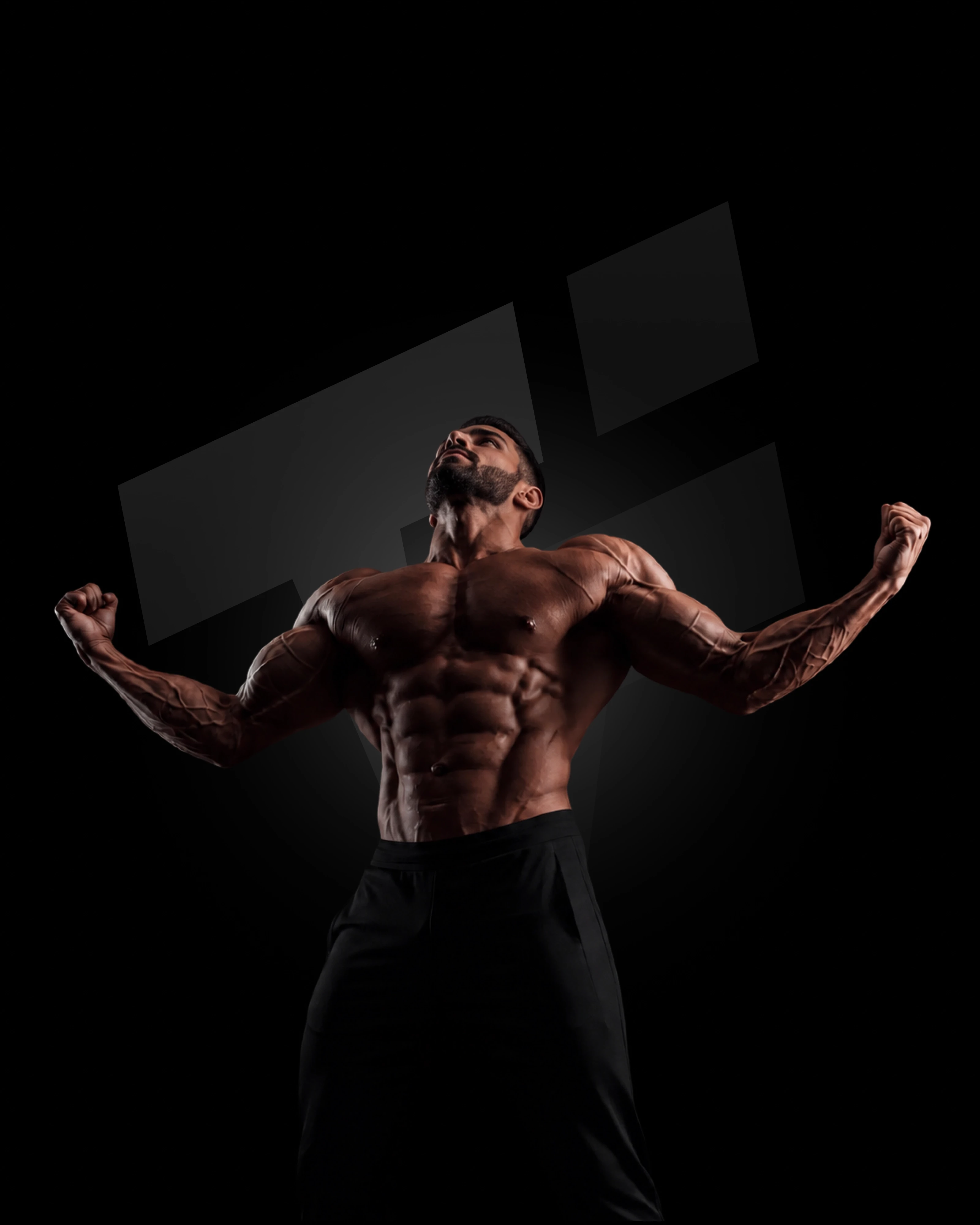 A muscular man flexing his well-defined arms and back muscles against a dark background. He is wearing black athletic shorts, and his powerful pose highlights the results of dedicated strength training and bodybuilding.