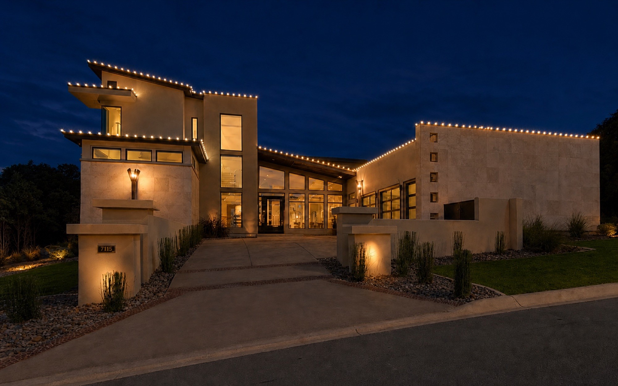 Wall wash uplighting beneath a lit roofline