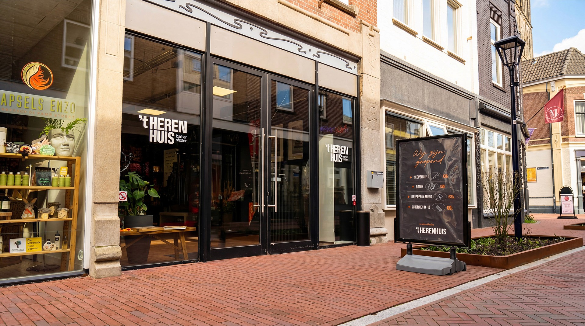 Barber in a striped cape getting a haircut