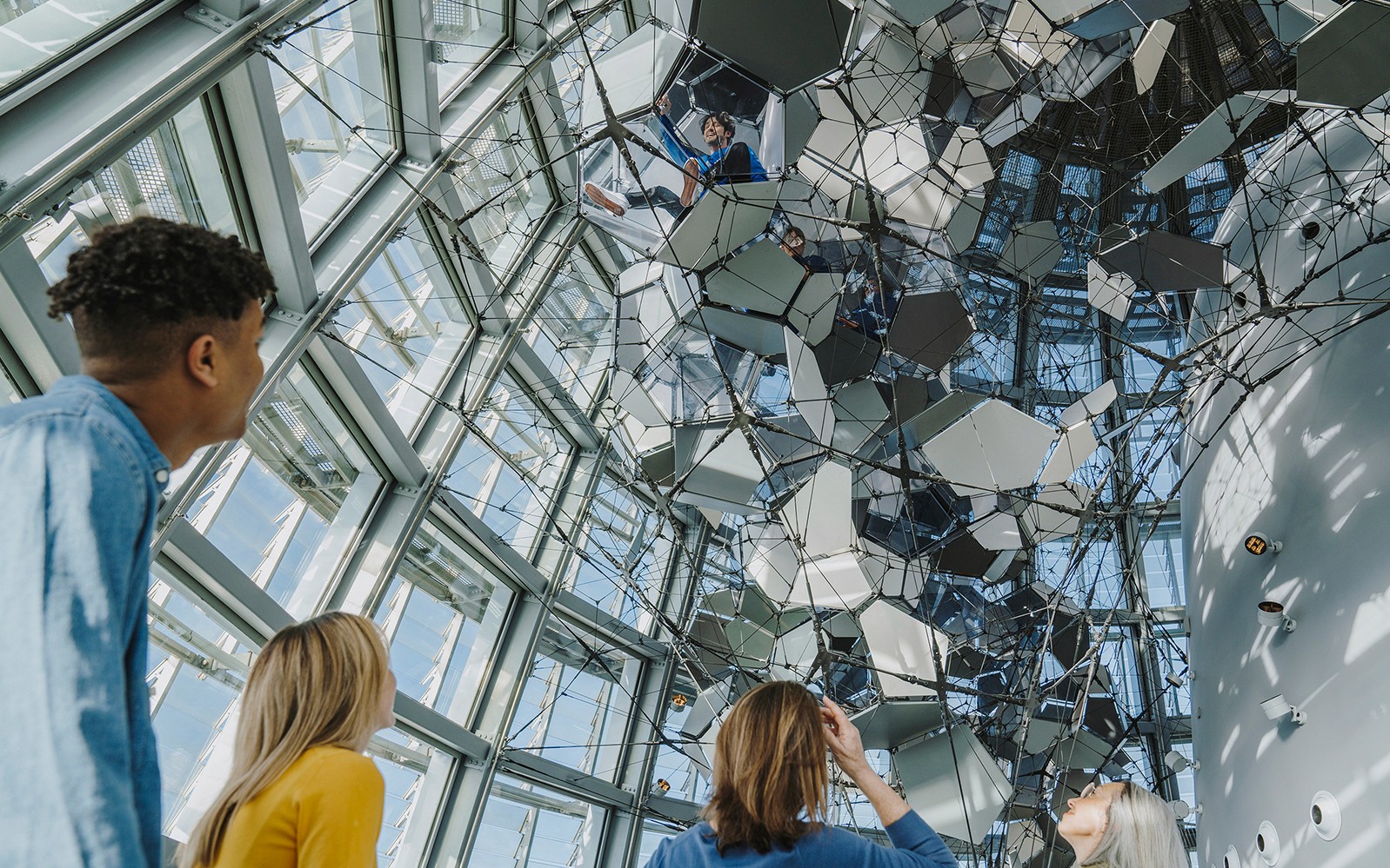 Visitors observing the geometric ceiling at Torre Glories Lookout.