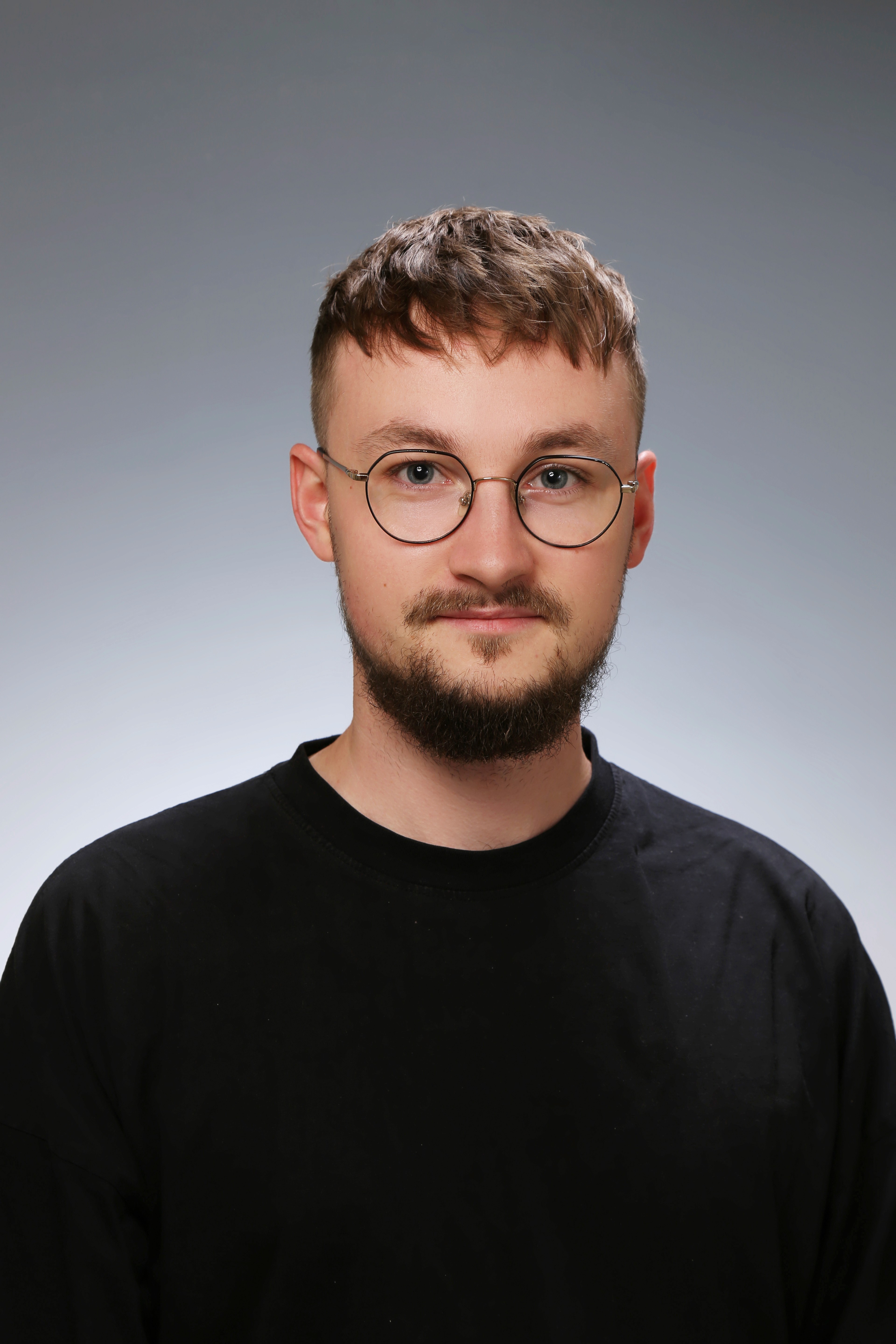 Profile portrait of a man in a grey shirt