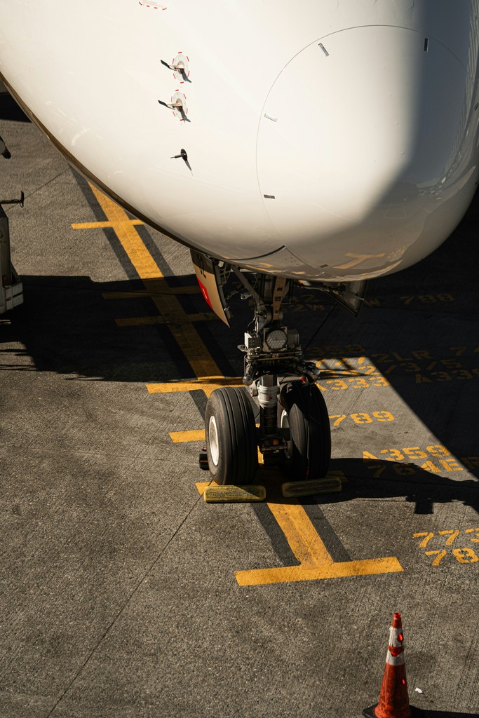 Airplane nose gear on tarmac with yellow markings