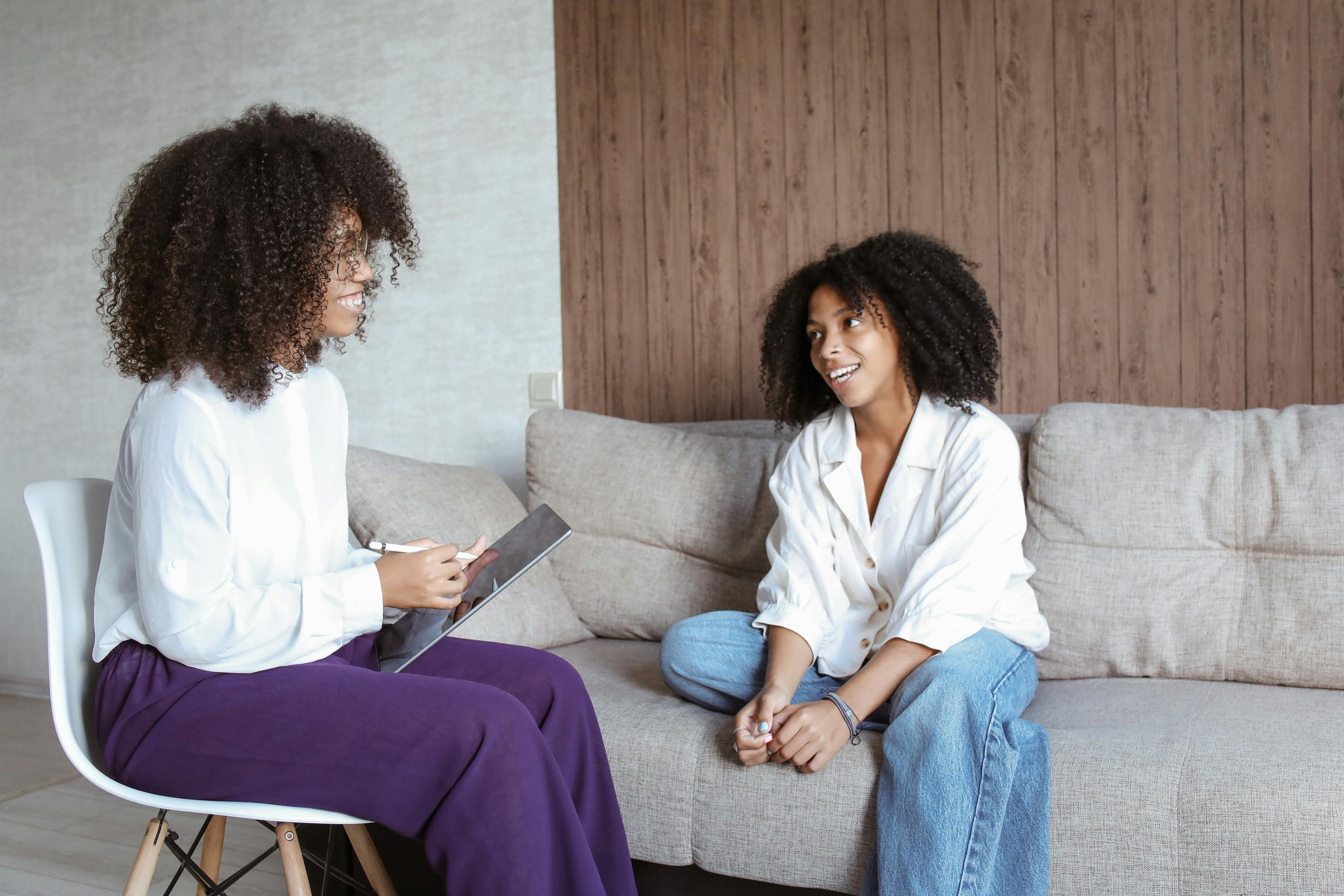 A psychologist and her client chatting in an office