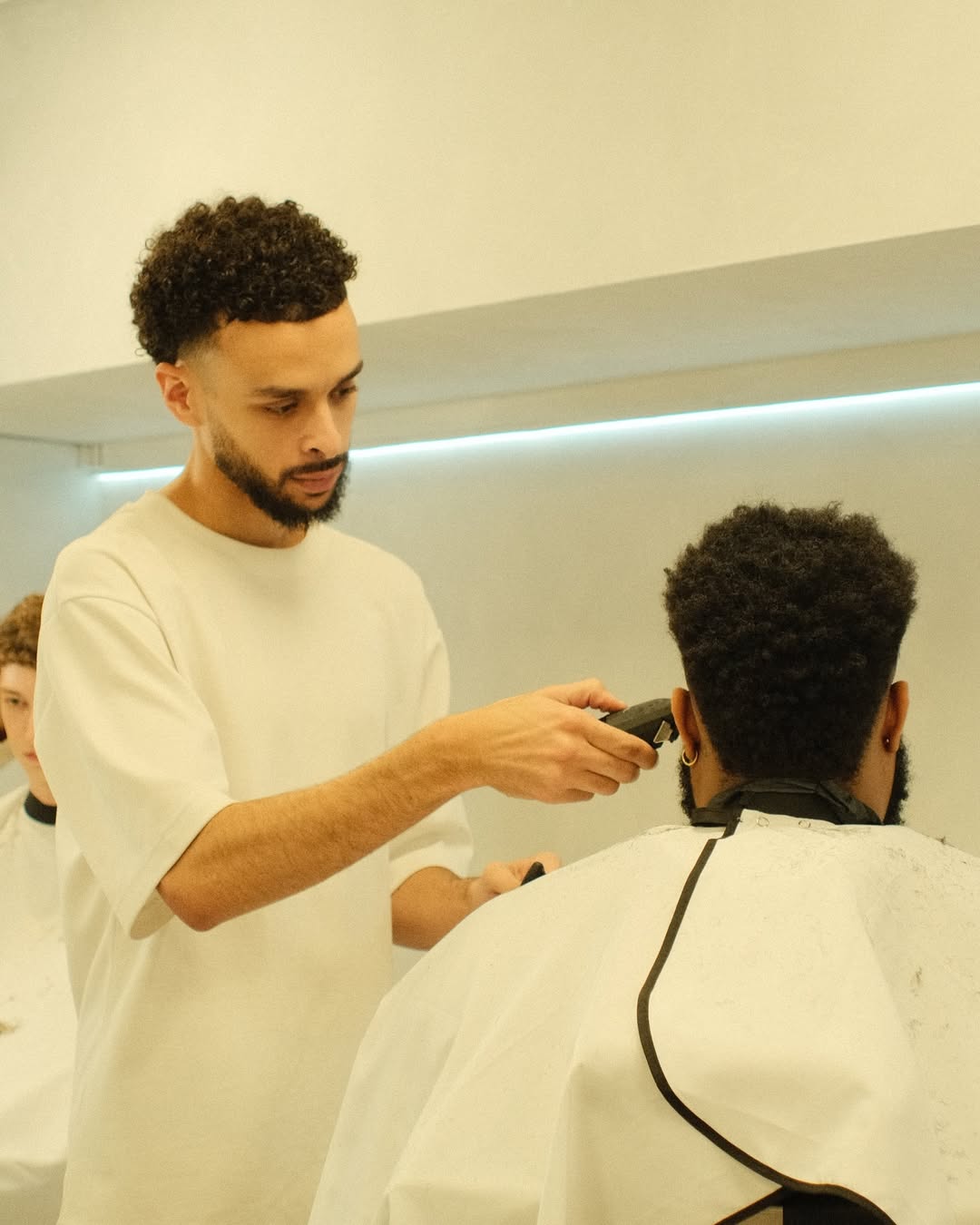 Barber Cutting Clients Afro Hair.