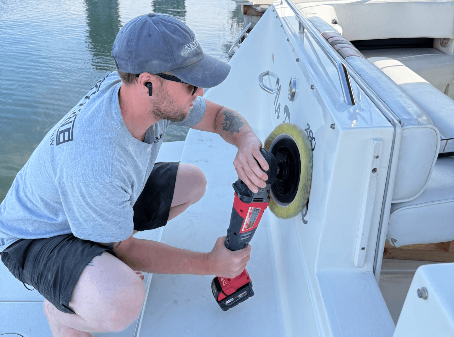 A man polishing and detailing the hull of a boat