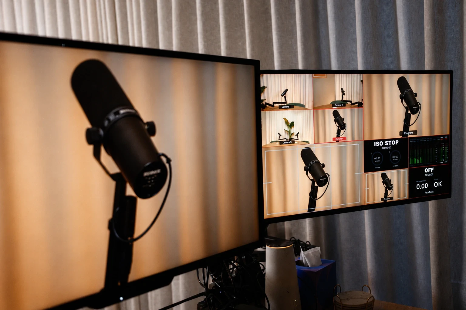 a microphone and camera monitor in front of the COVE set’s lamp-lit shelving