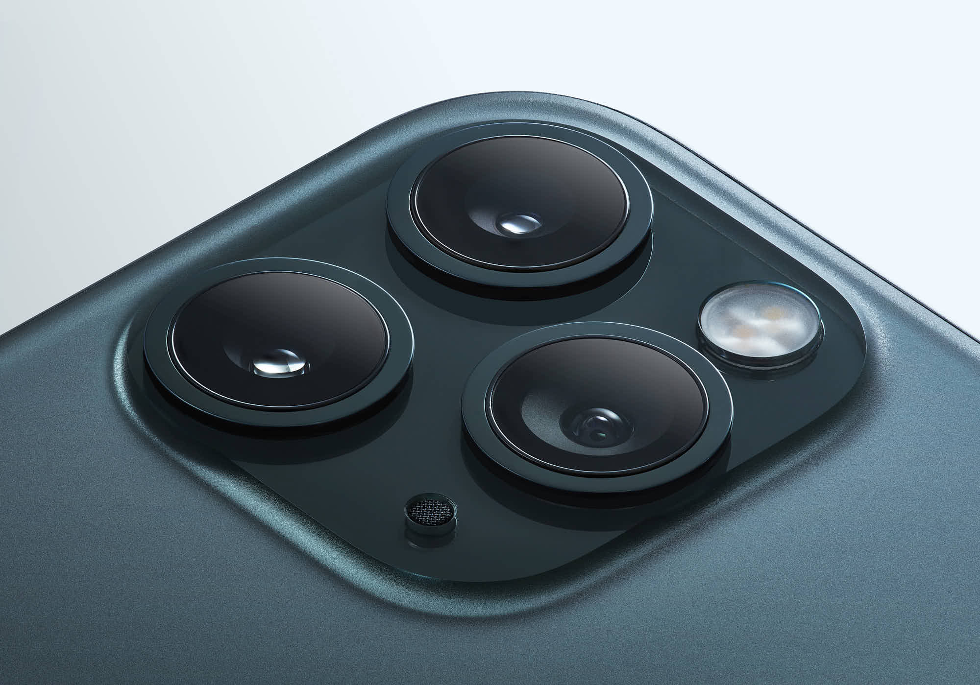 Close-up of smartphone triple-lens camera system, sleek design.