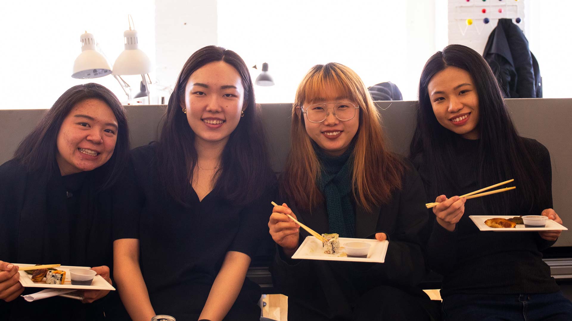 four students from venture 19 with sushi