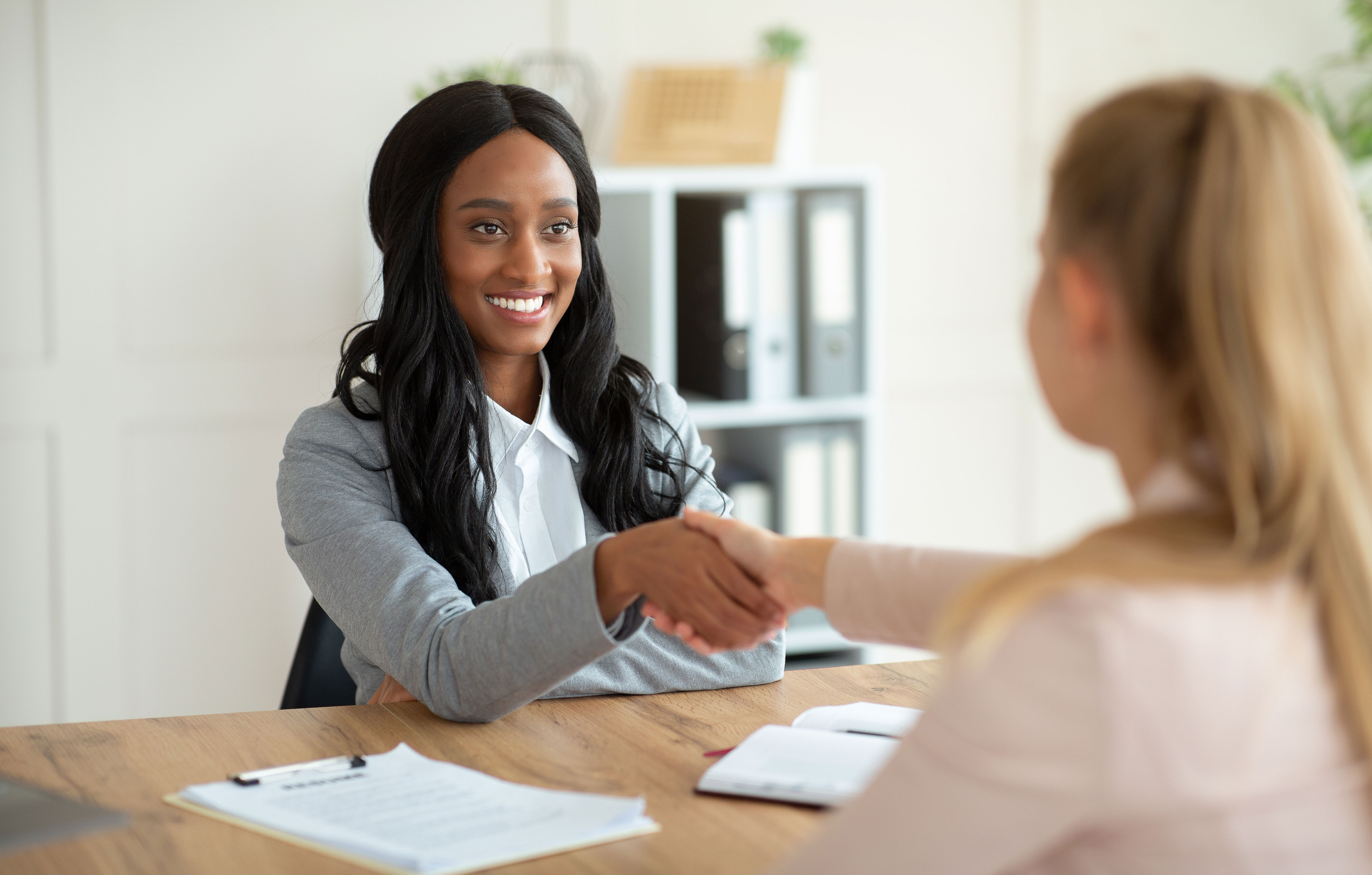 Student practicing interview answers with a mentor across a small table.
