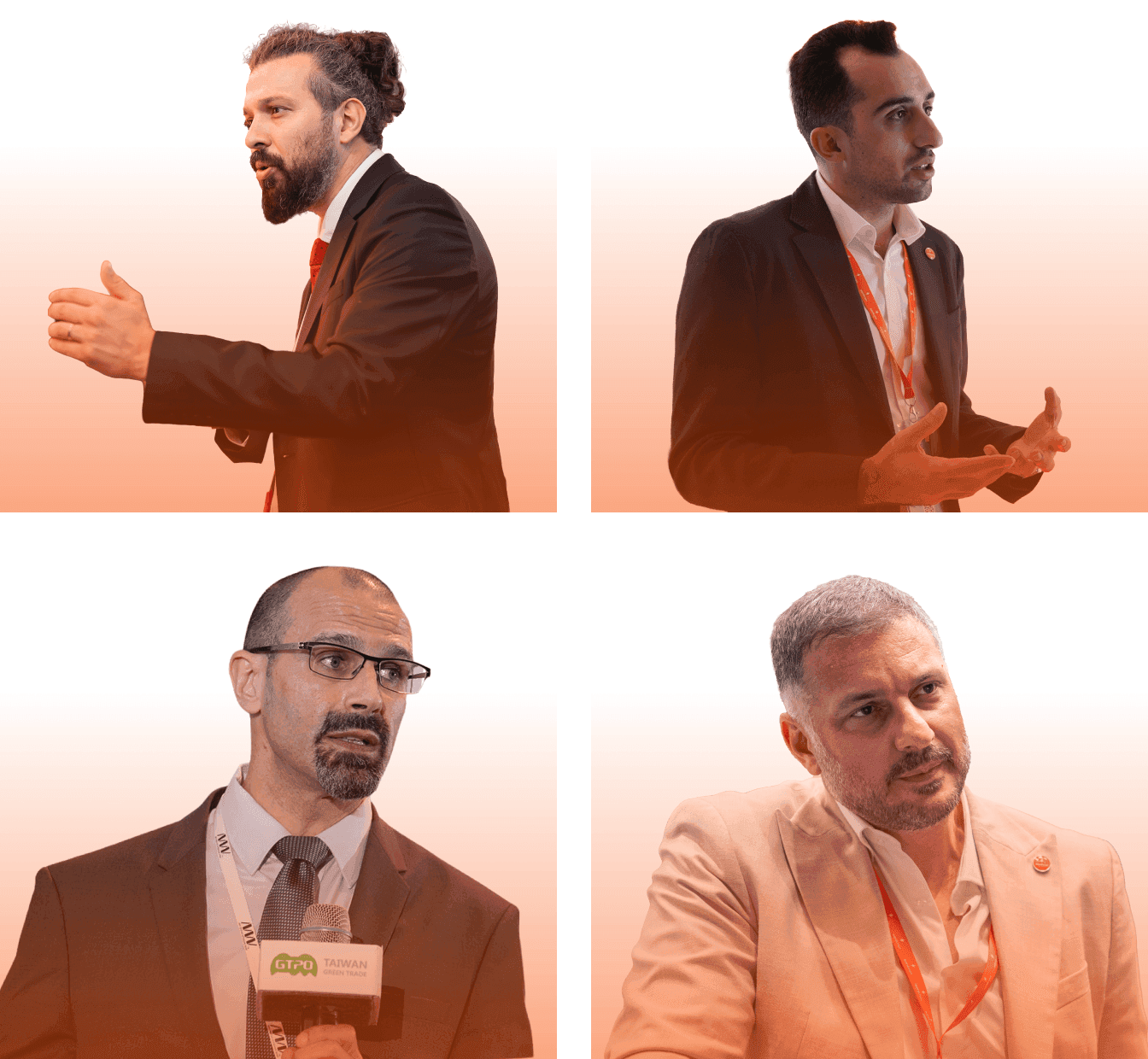 A diverse group of people poses together in front of a bright, red backdrop at an event or conference.