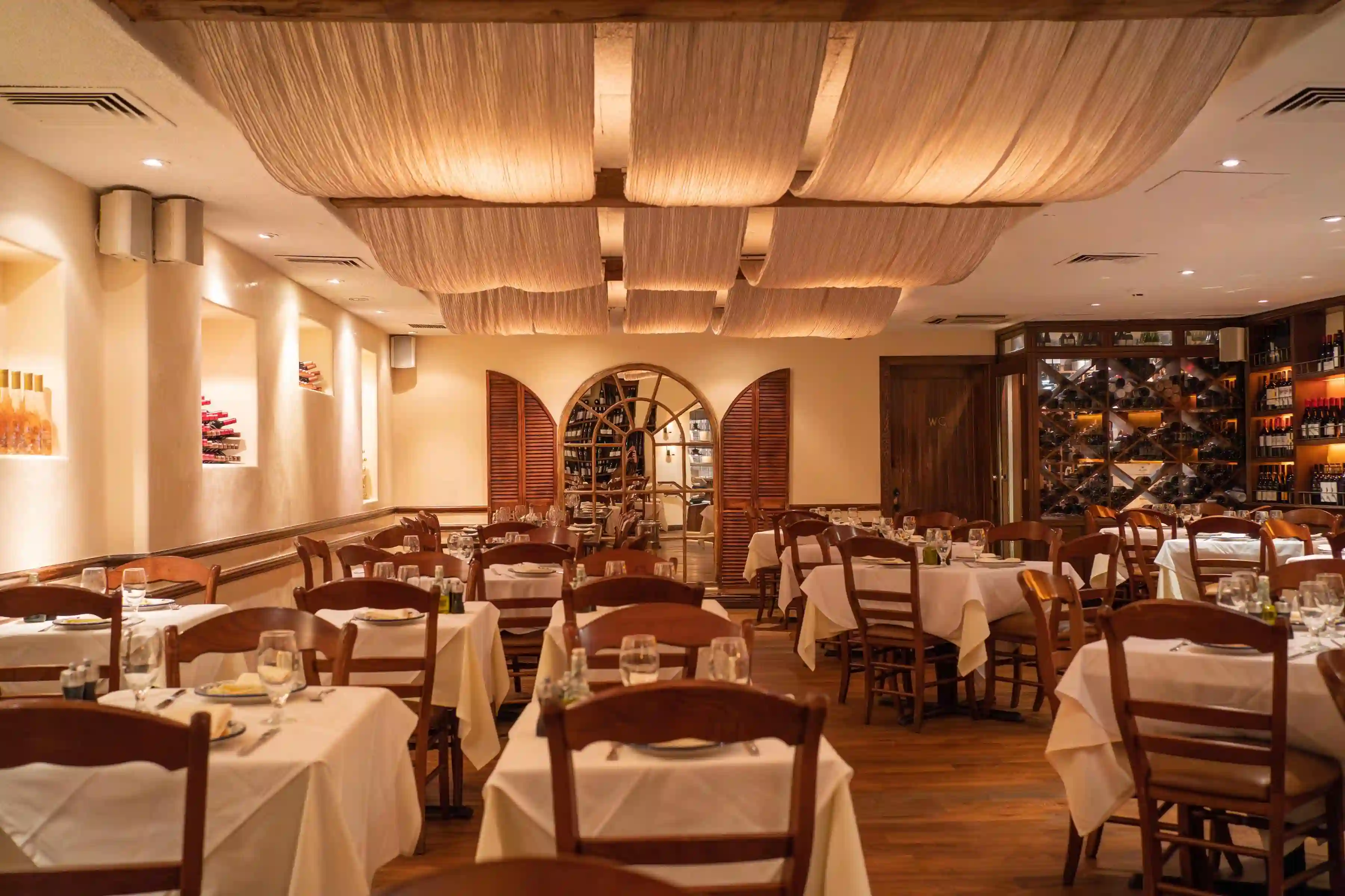 Cozy restaurant interior featuring wooden tables, warm lighting, and a welcoming atmosphere.