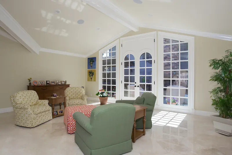 Bright lving room seeting area with large french doors and sideites from the Big Canyon Remodel project. Photo by Chris Darnall.