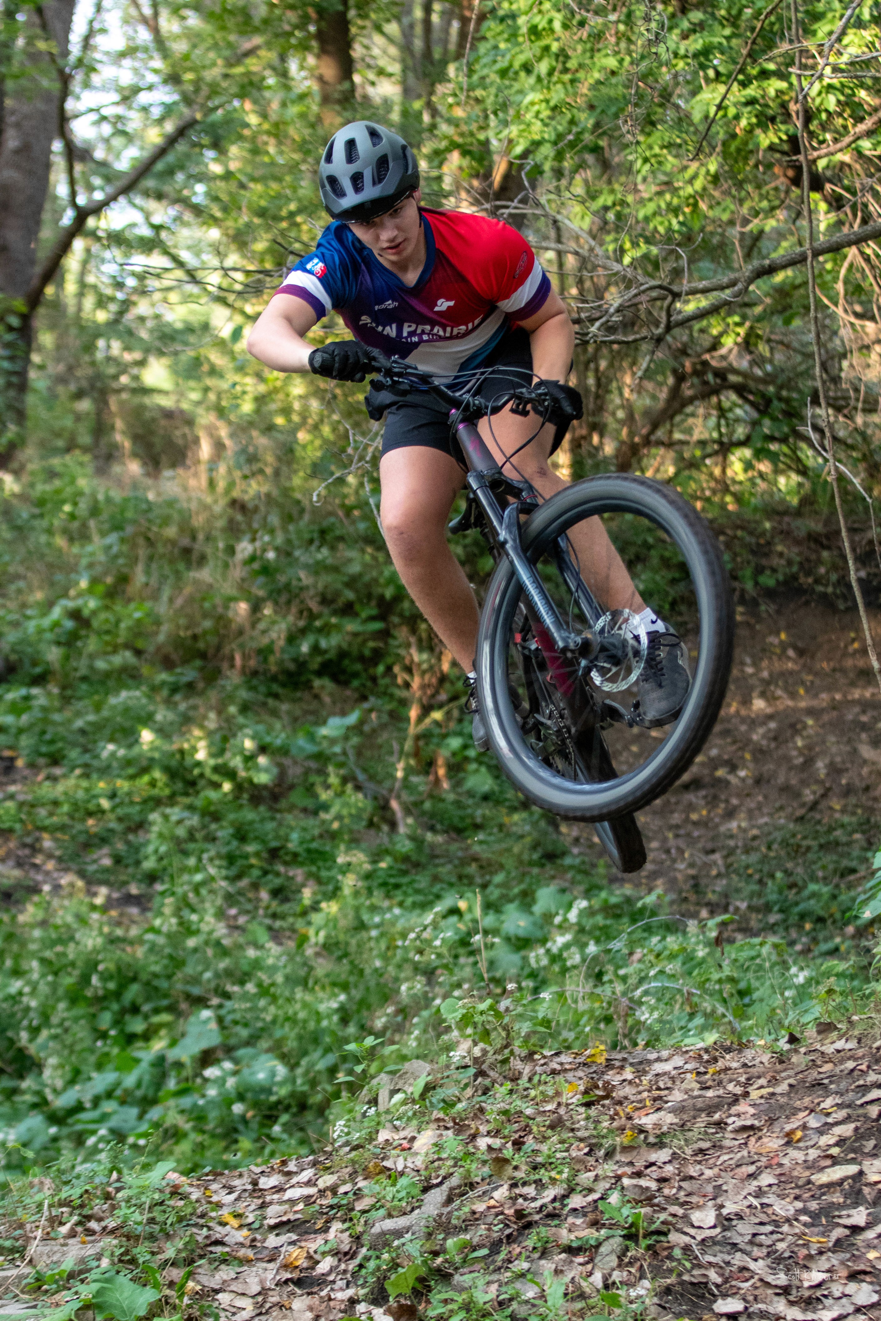 mountain biker jumping through the air