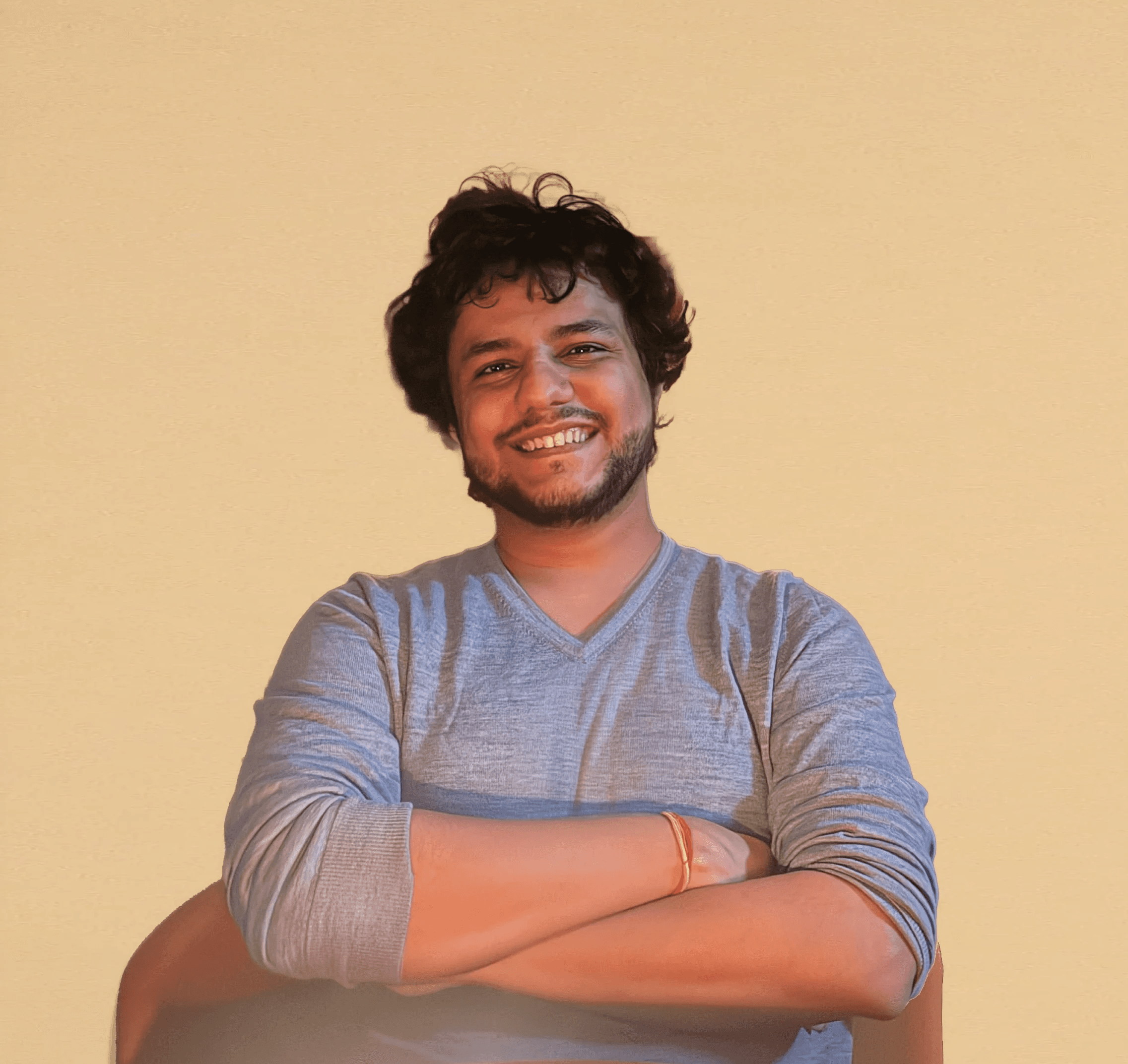 Portrait of a person in a pink sweater against a light background