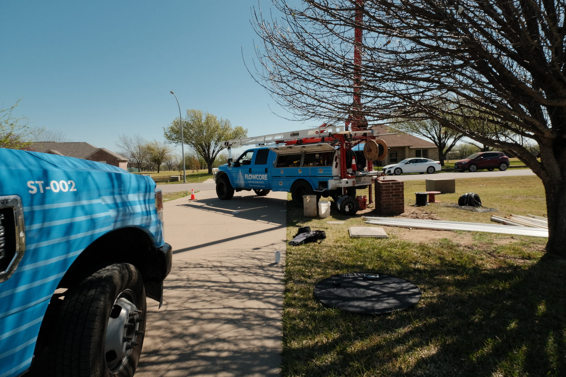 Flowcore Water Services drill rig and service truck ST-002 on a residential water well installation job site in North Texas — DFW well drilling and water services