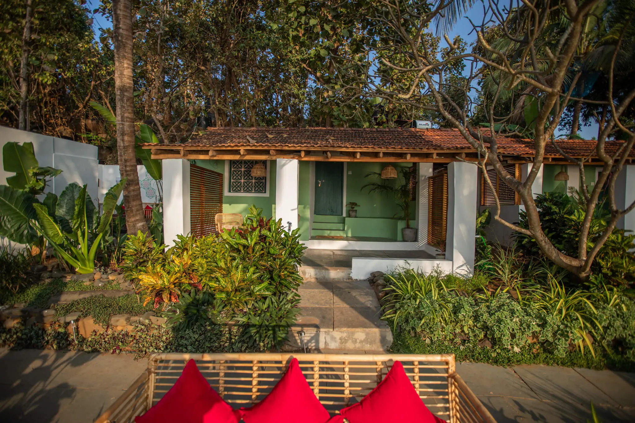 Sea View Room 4's cottage entrance amid Casa Jaali's gardens