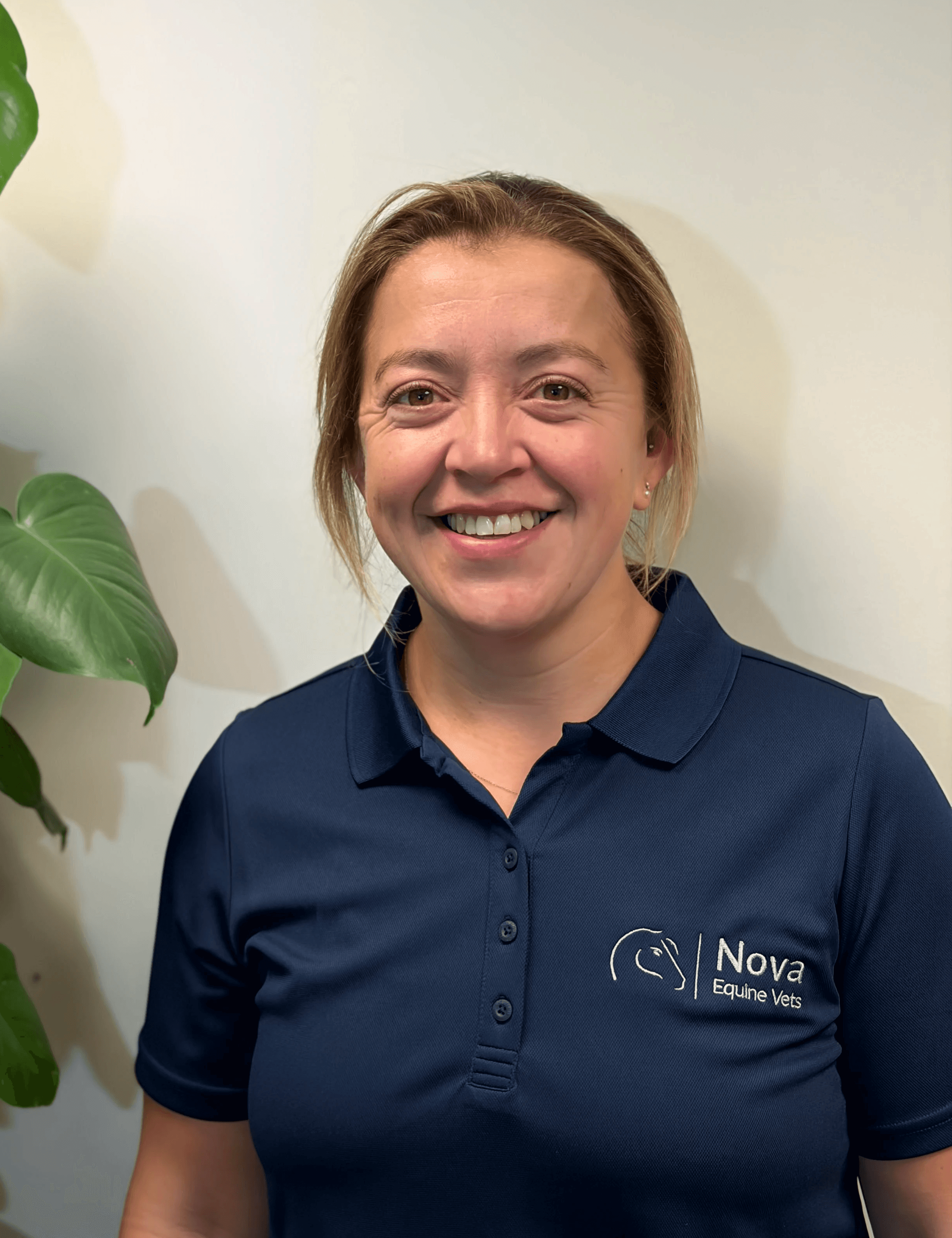 a man in a blue shirt smiling at the camera