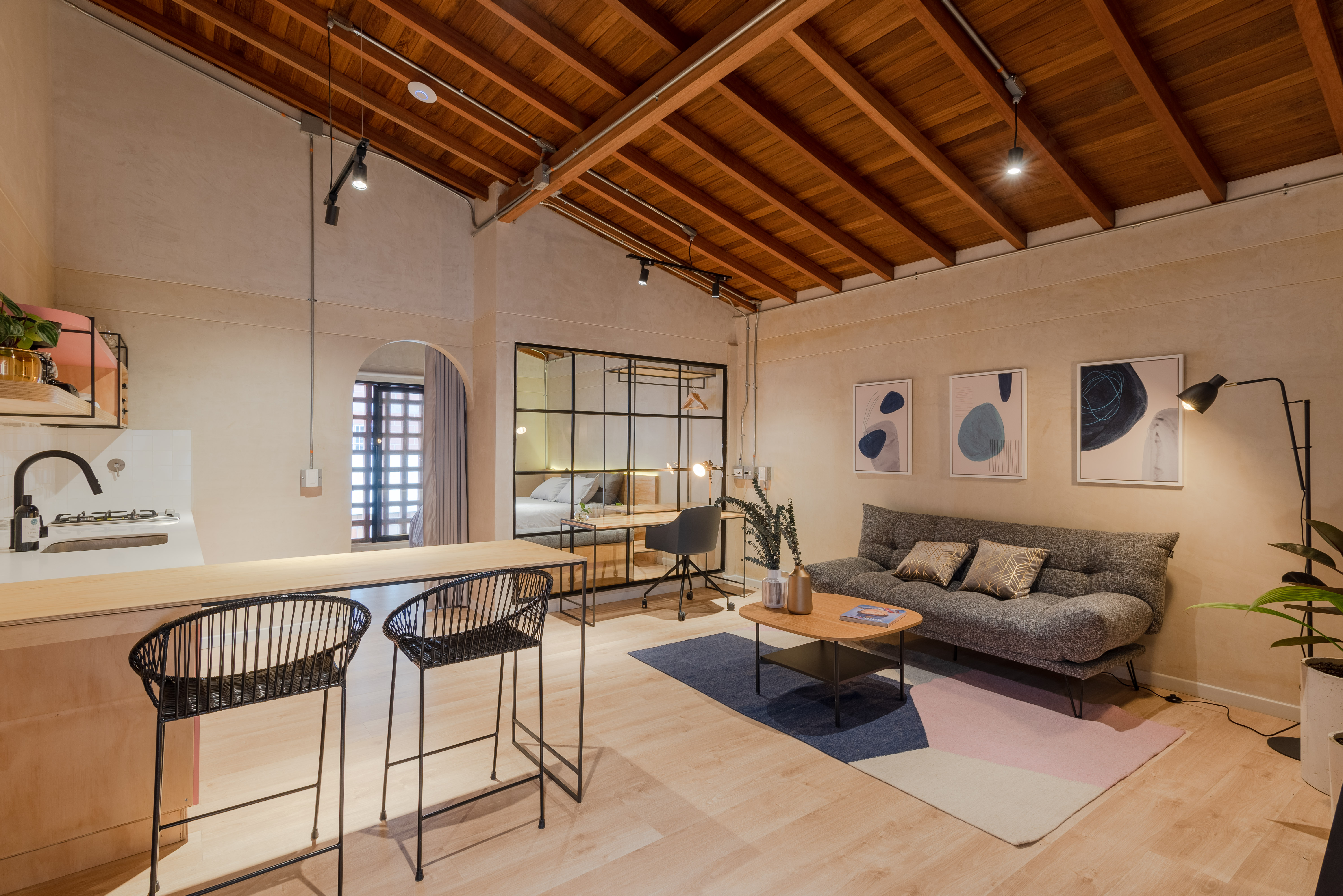 Double-height interior with flowing sculptural forms and warm raking light