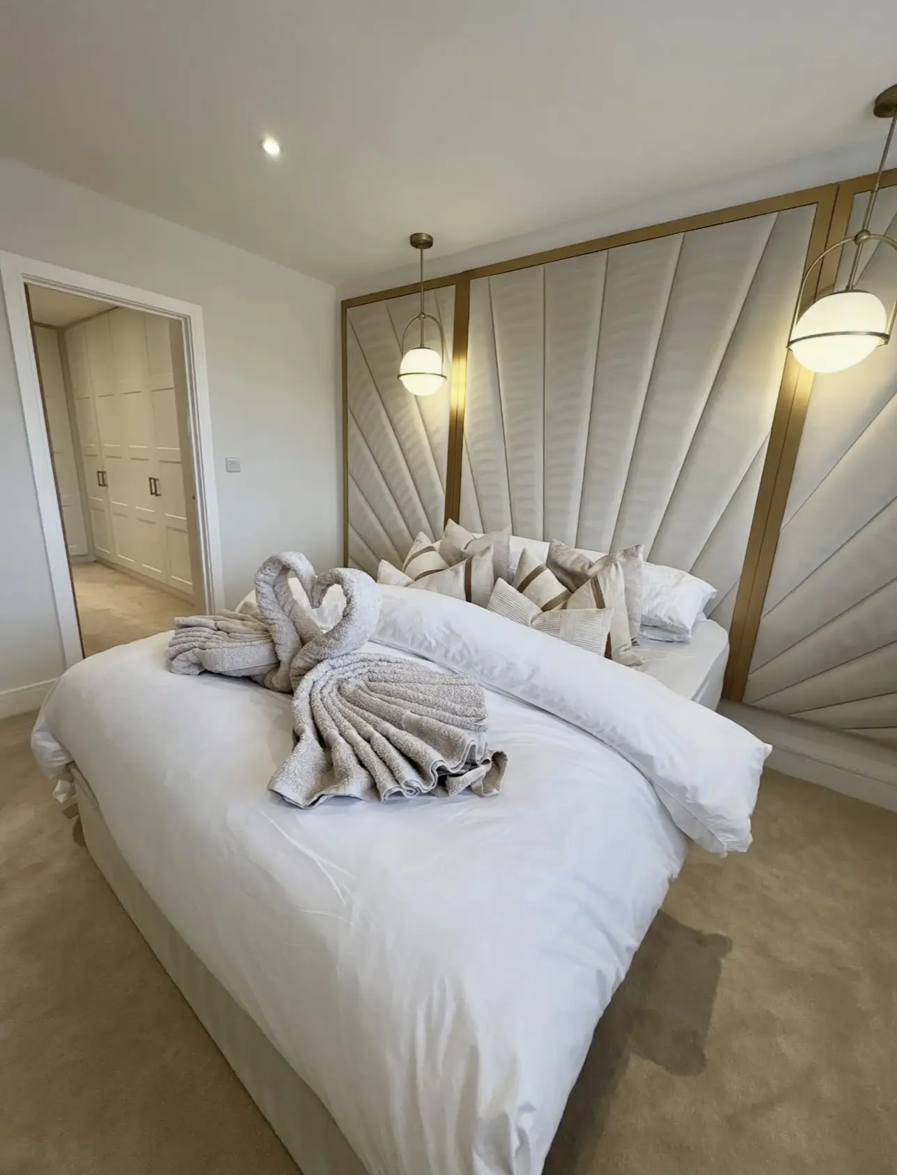A pristine Gilbert, AZ bedroom displaying detailed finishing touches and a professionally made bed after a residential cleaning.