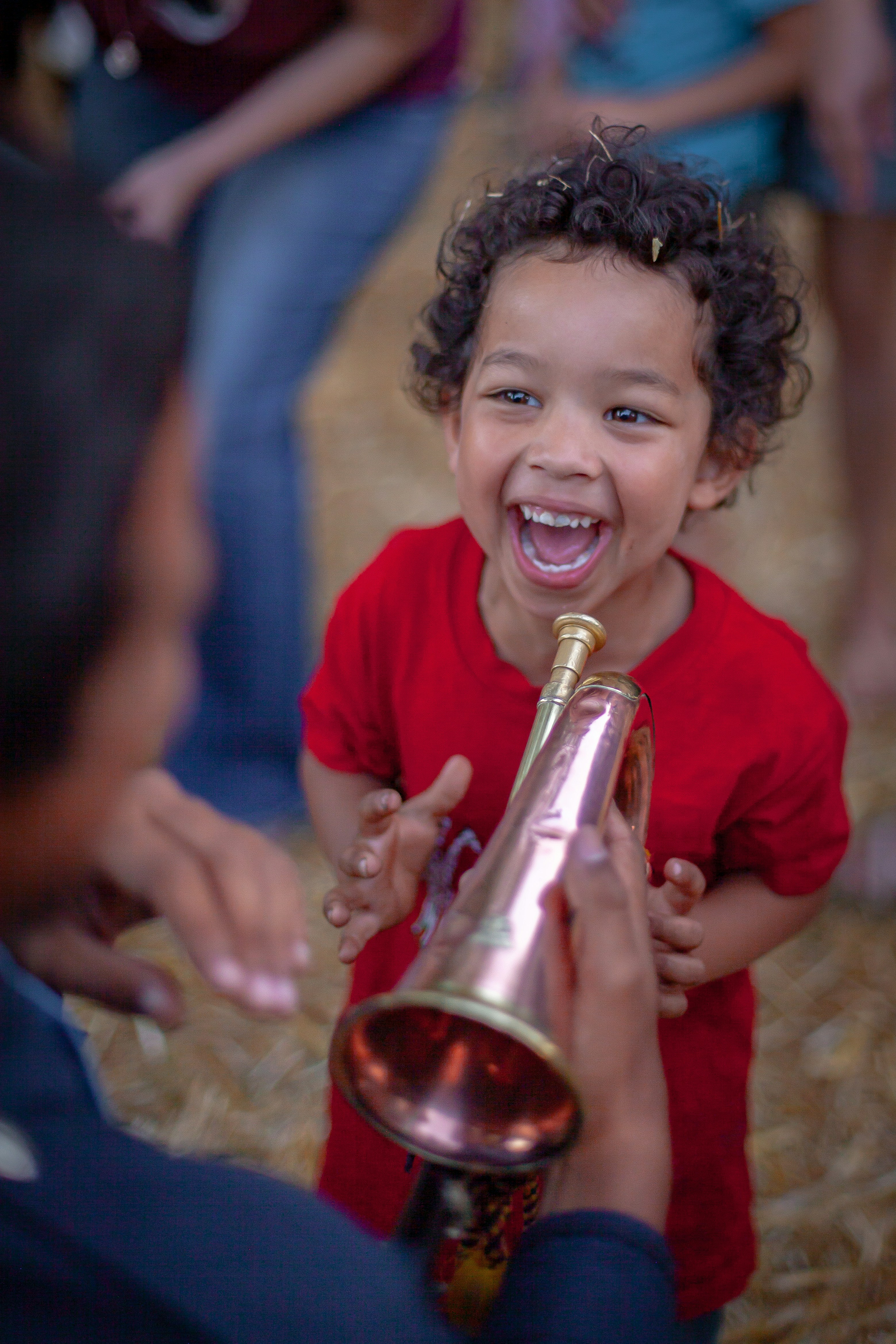 a little boy is holding a champagne bottle and laughing