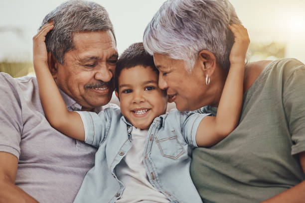 Grandparents hugging their grandson while considering savings options like Trump Accounts and 529 plans