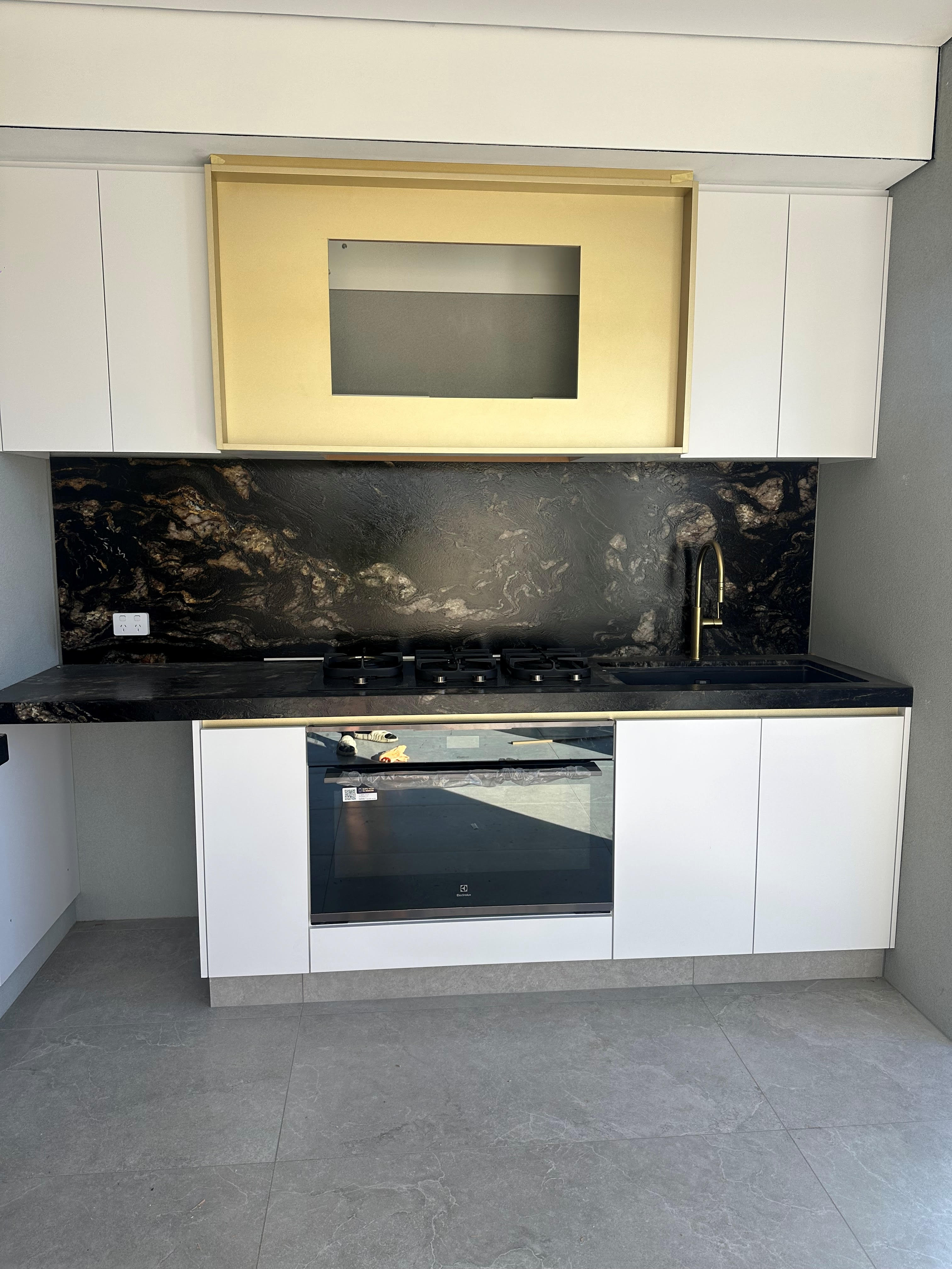 Electrician drilling in a wall