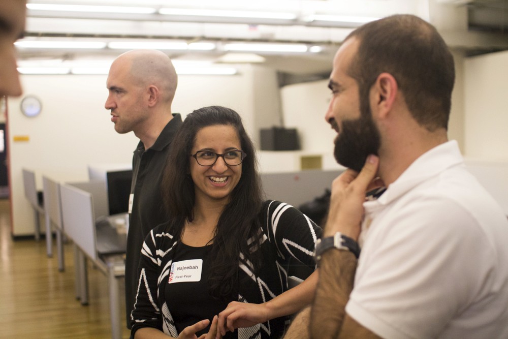 photo of two people talking at the exhibition gallery