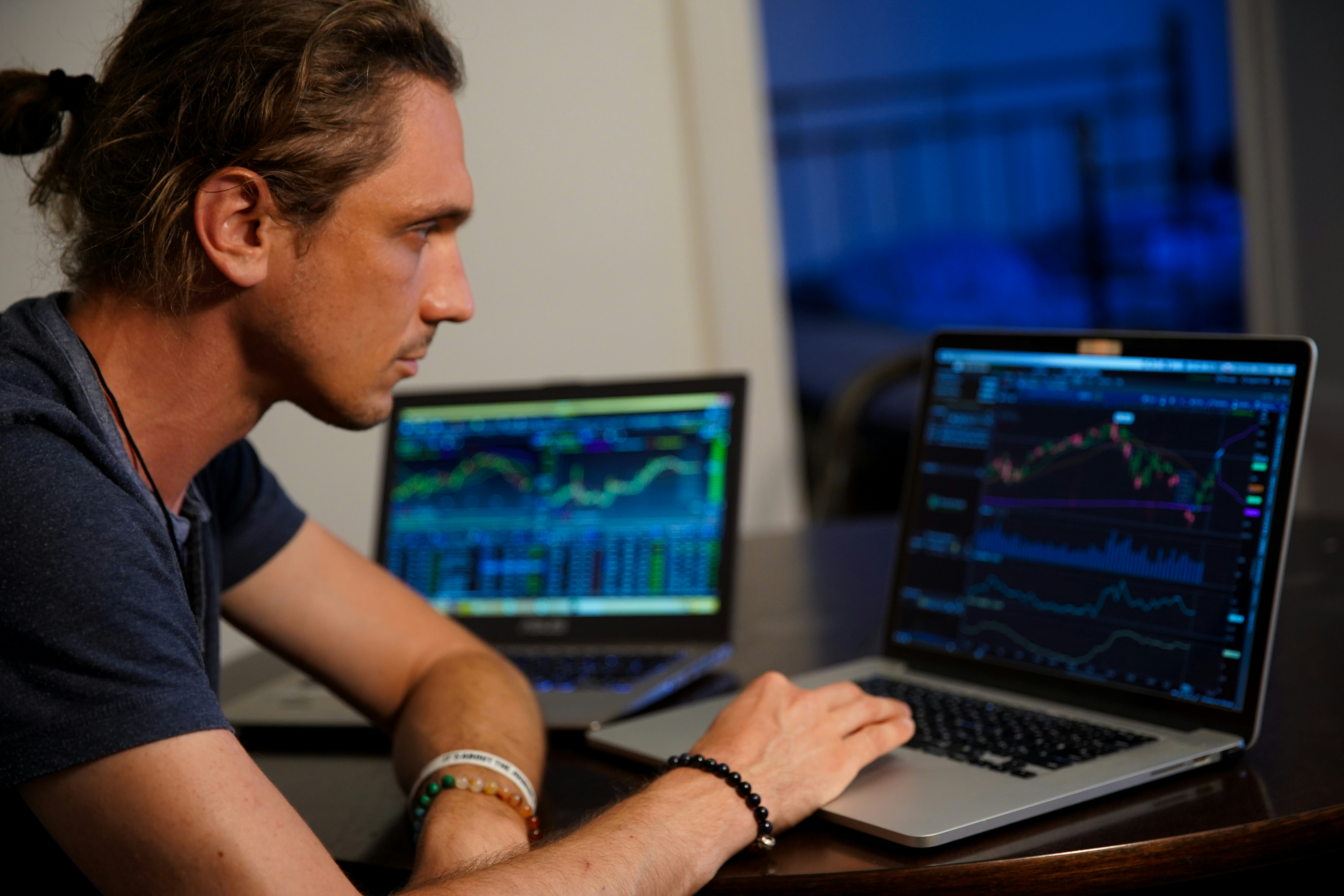 person infront of multiple laptop - Crypto Trading Strategies