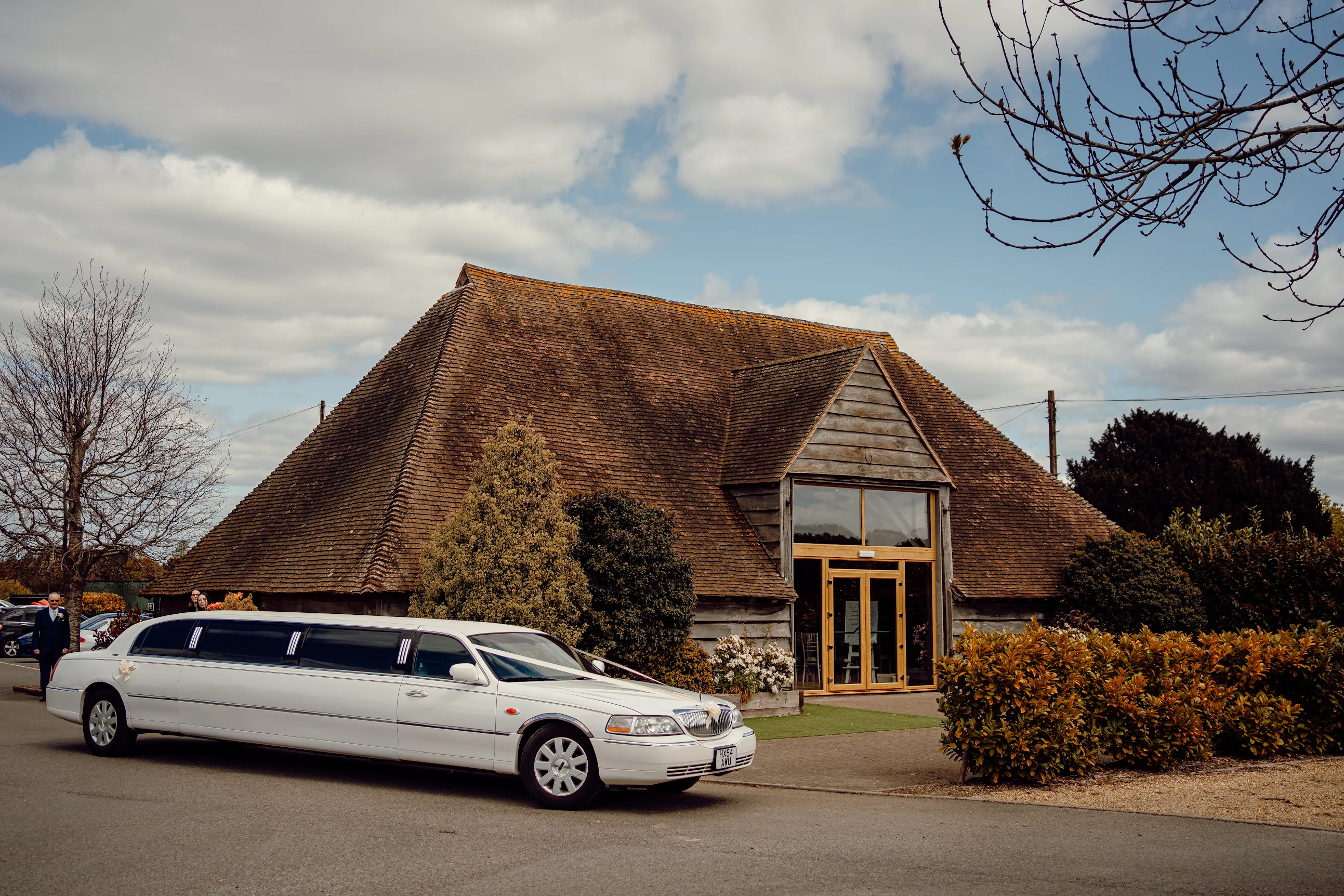A charming rustic building with dark wood siding and a red-tiled roof houses "The Garden Room," 