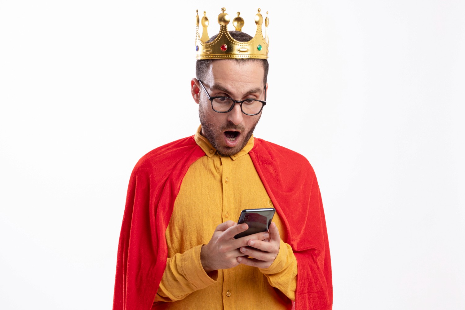  A man wearing a crown and glasses is holding a cell phone, showcasing a blend of royalty and modern technology.