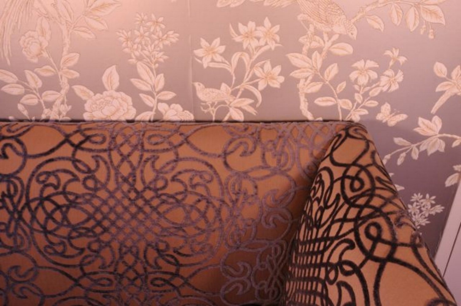 Patterned wallpaper and upholstered bench detail in a Lafayette bungalow.