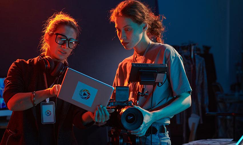 a group of people standing around a camera set up