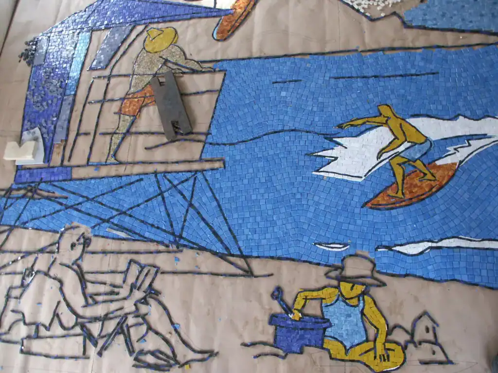 Vibrant mosaic mural depicting surfers and ocean waves at San Diego Airport.
