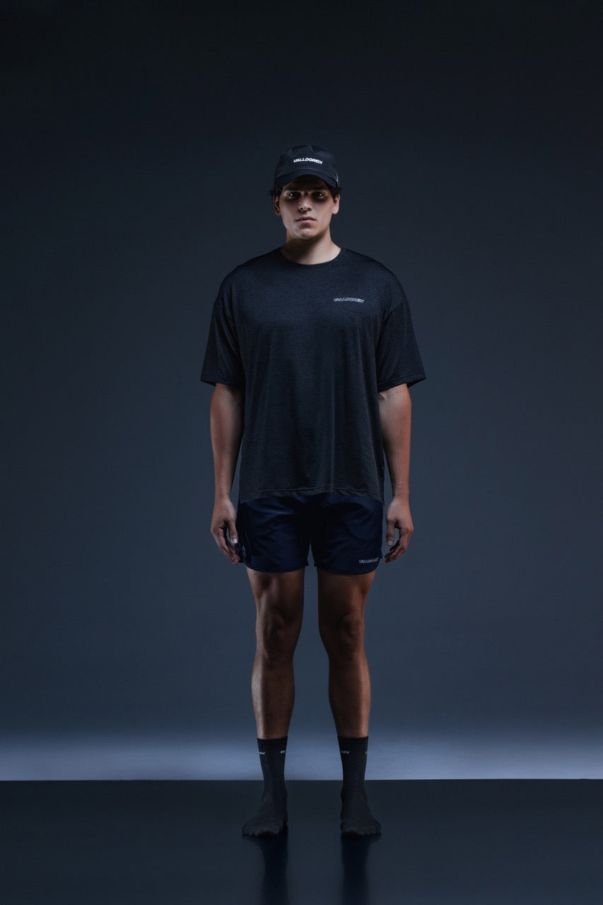 Valldoreix model in dark tennis apparel against a studio backdrop