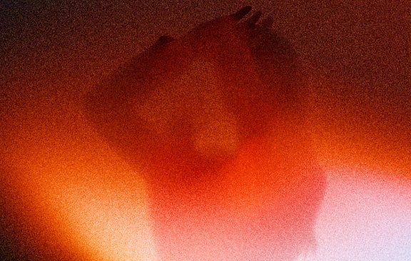 a person riding a snowboard on top of a sandy hill