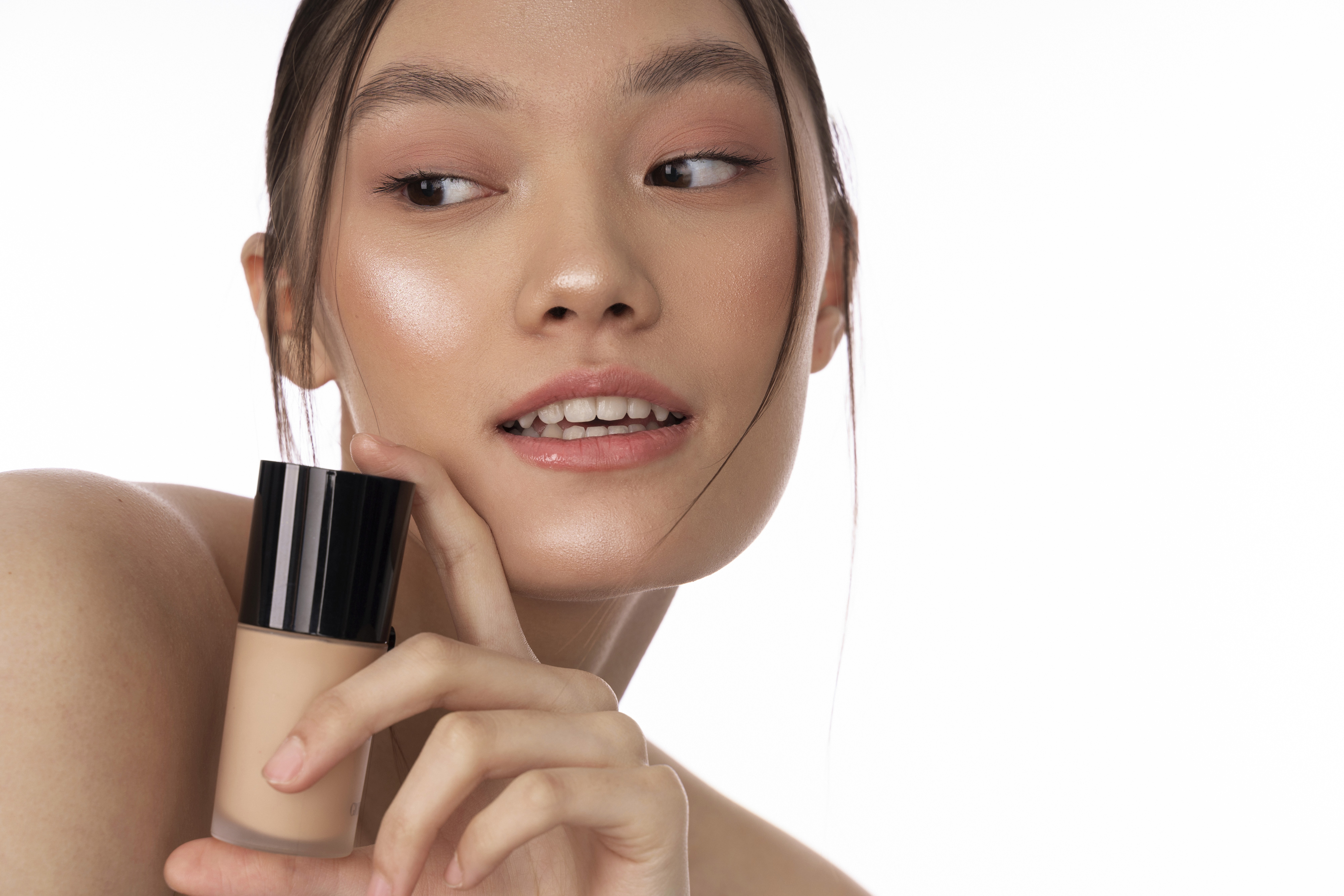 A close-up view of dark green leaves, creating a lush, textured background with subtle variations in color.