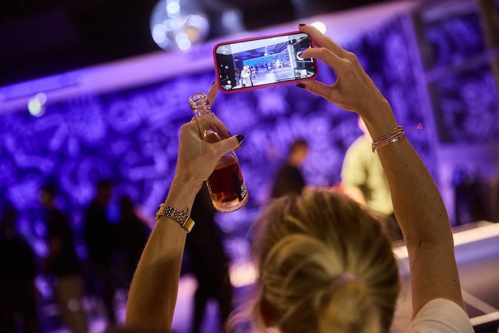 two ping pong paddles and a ping pong ball on a blue table