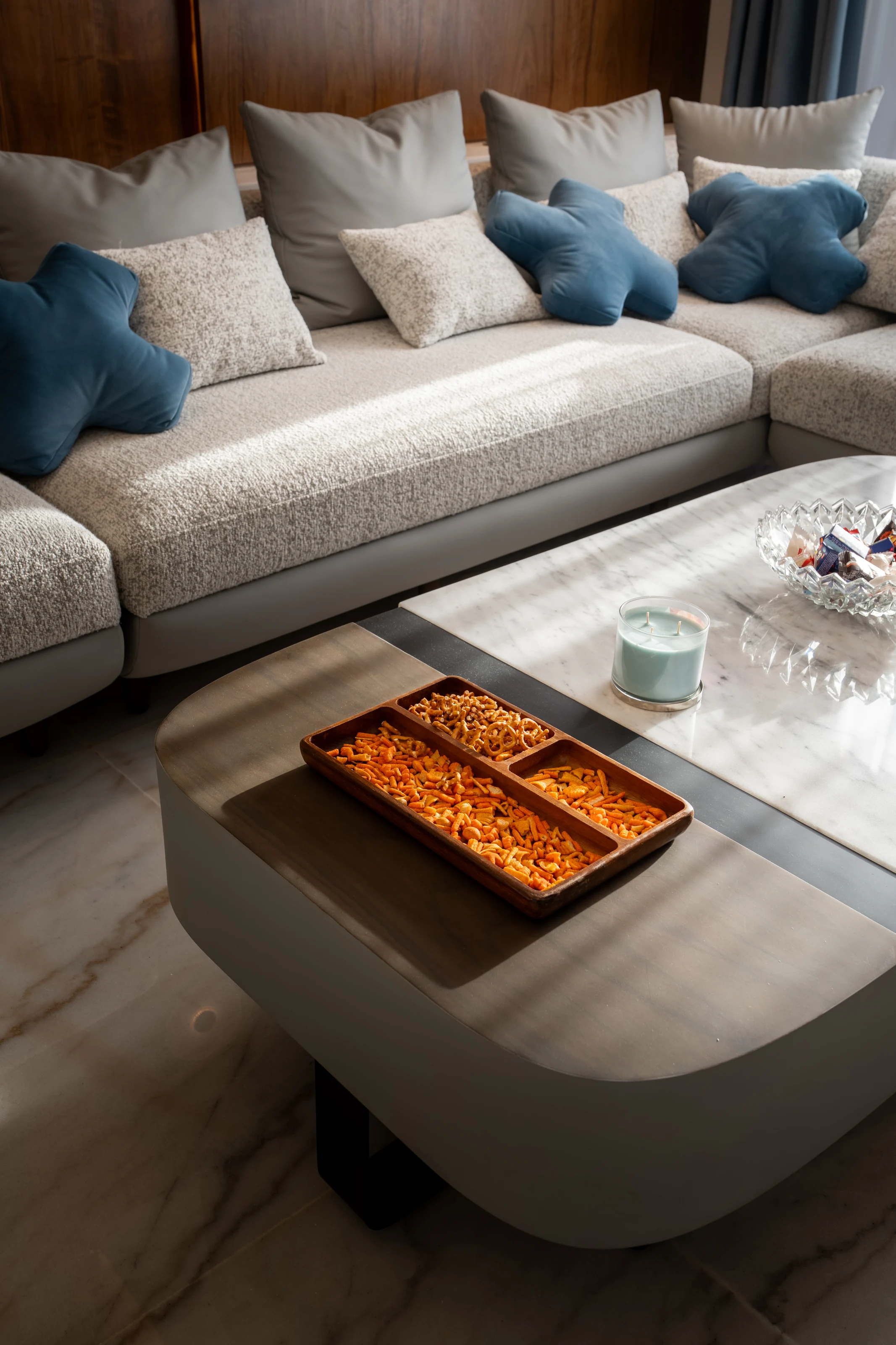 Custom coffee table and upholstered sectional detail in the Mivida Twin Villa living room.