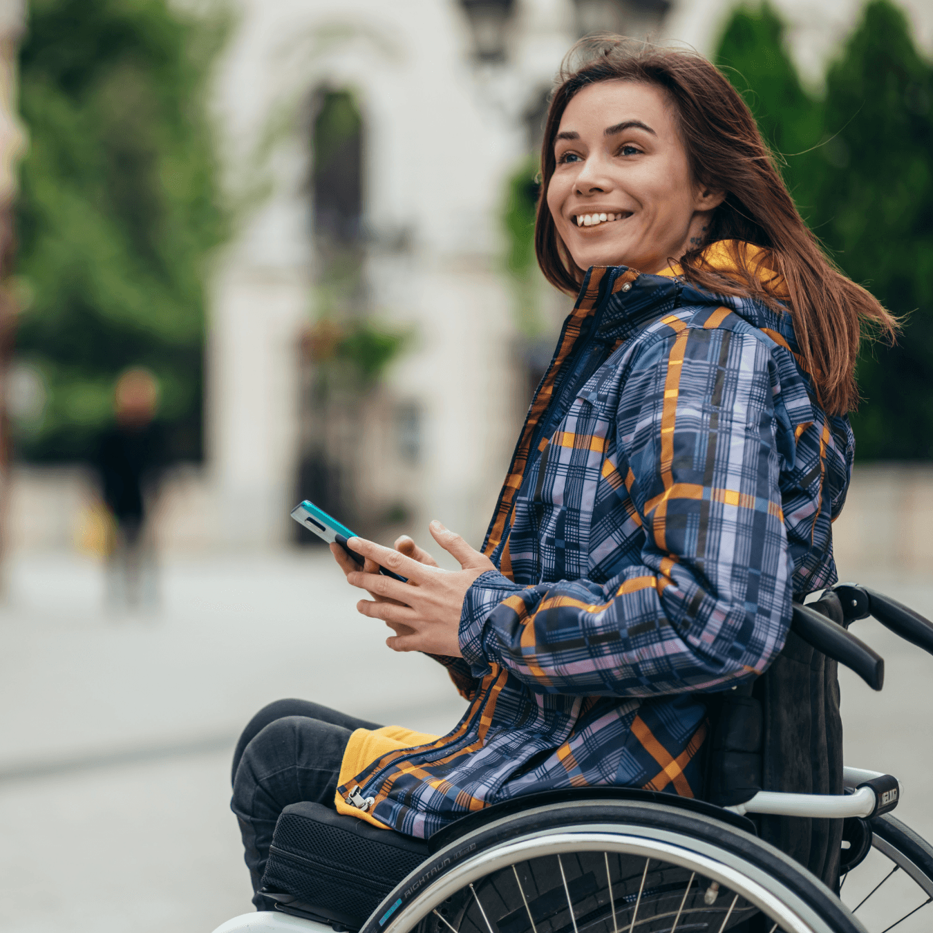 two people in wheelchairs enjoying coffee out side