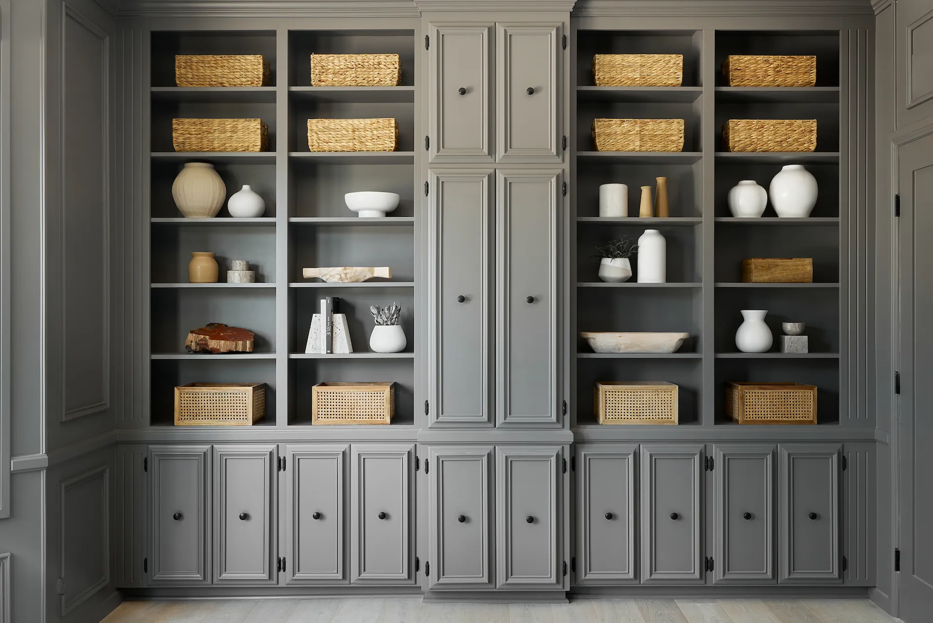 View of the storage wall with built-in cabinetry in the primary bedroom in this Fullerton remodel. Photo by Todd Huge.