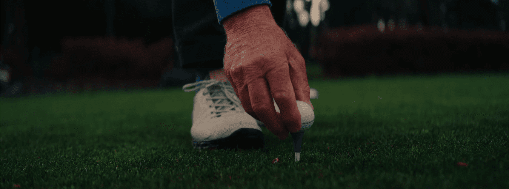 Gary Goodman putting ball on tee