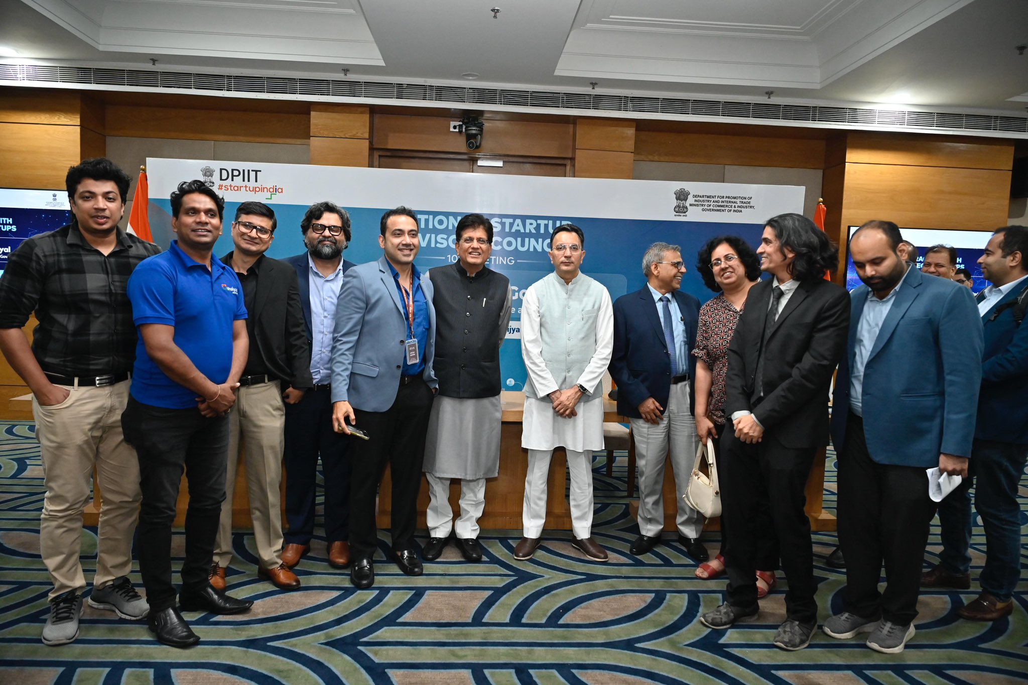 Attendees posing for a group photograph at a deeptech startups meeting in New Delhi, with Startup India branding on the event backdrop.