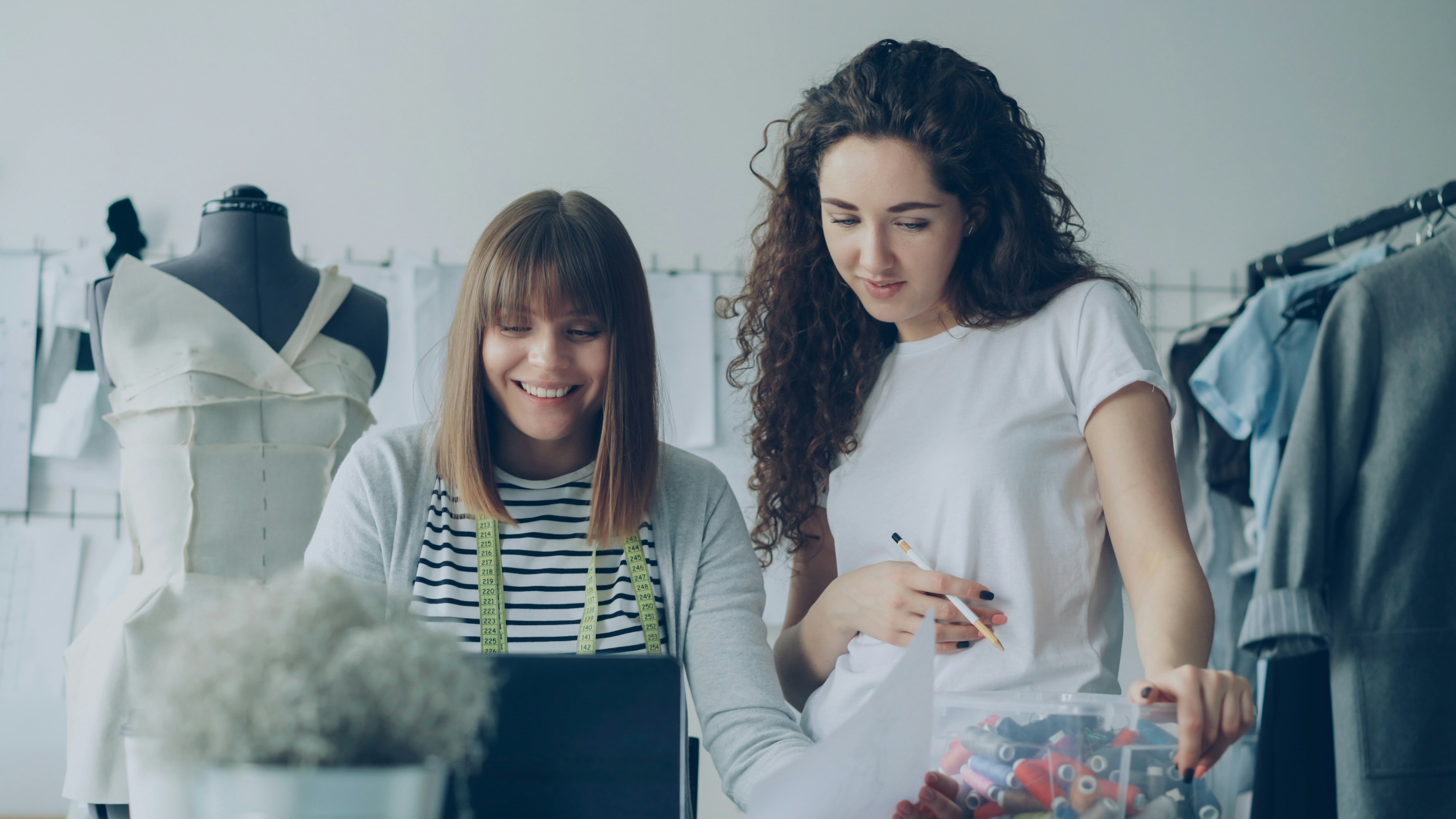 Two fashion designers collaborate on a project.