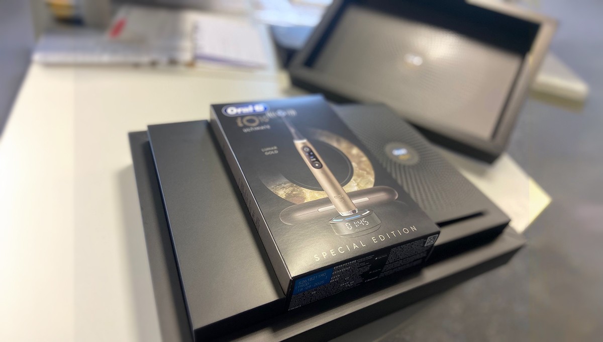 Family standing in a lush green field with tractor.