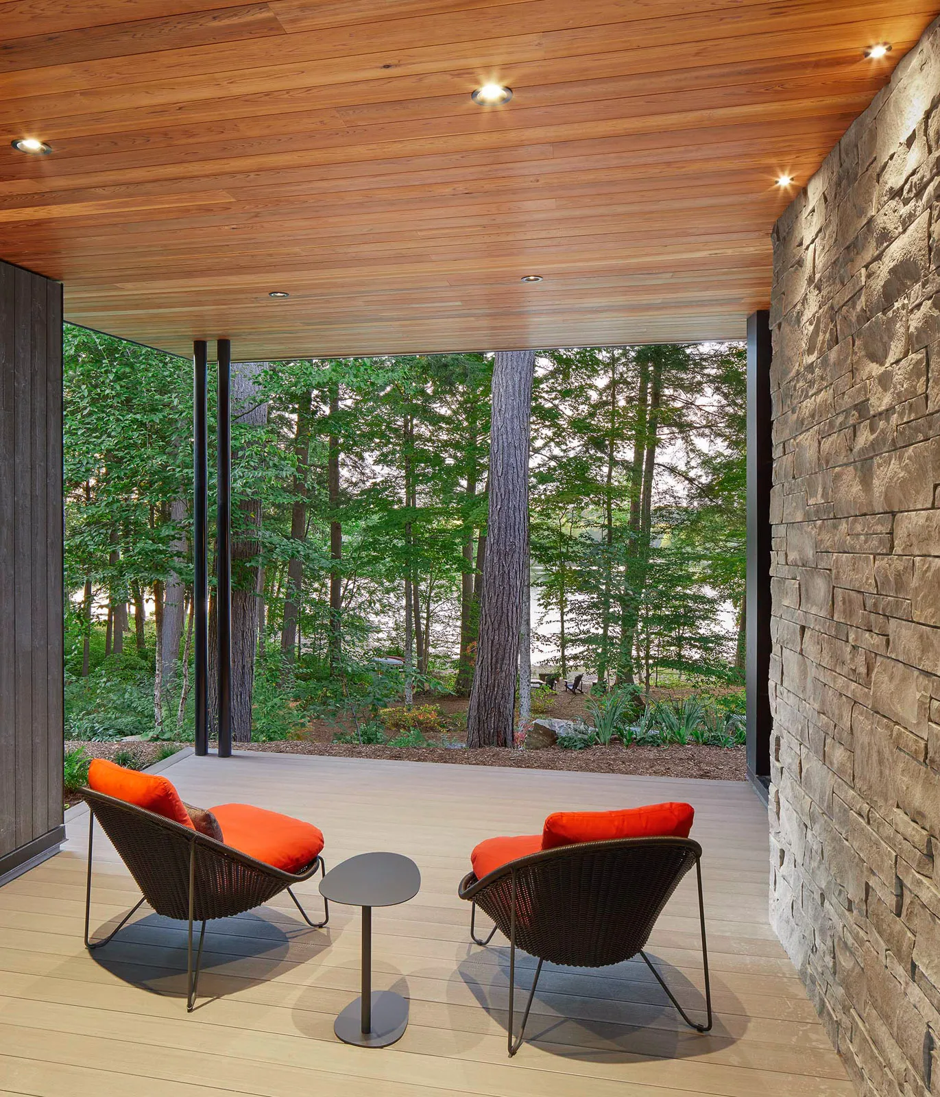 Private seating area on a secluded deck in haliburton with cedar plank ceiling.