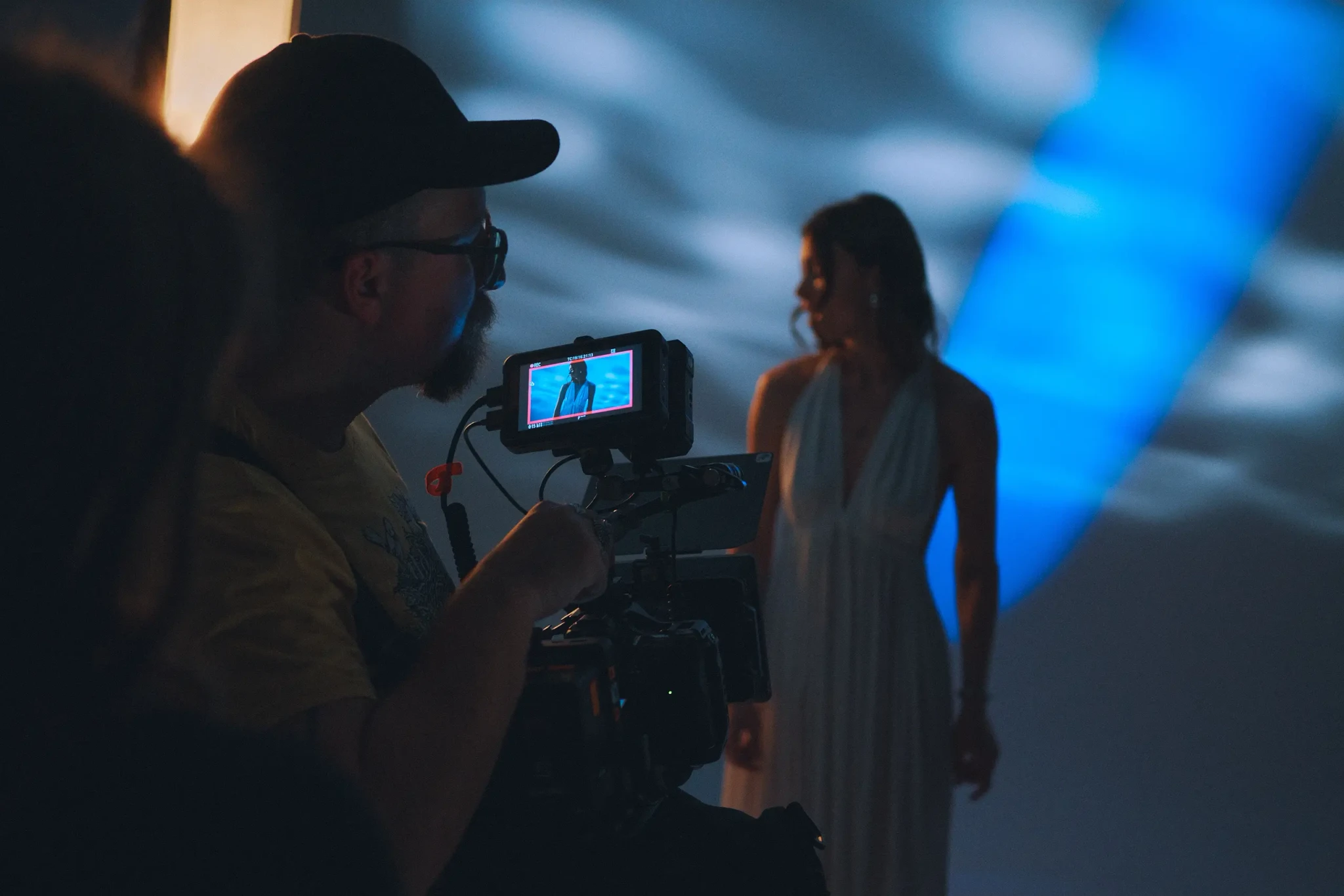 A man is holding a camera and filming a girl.