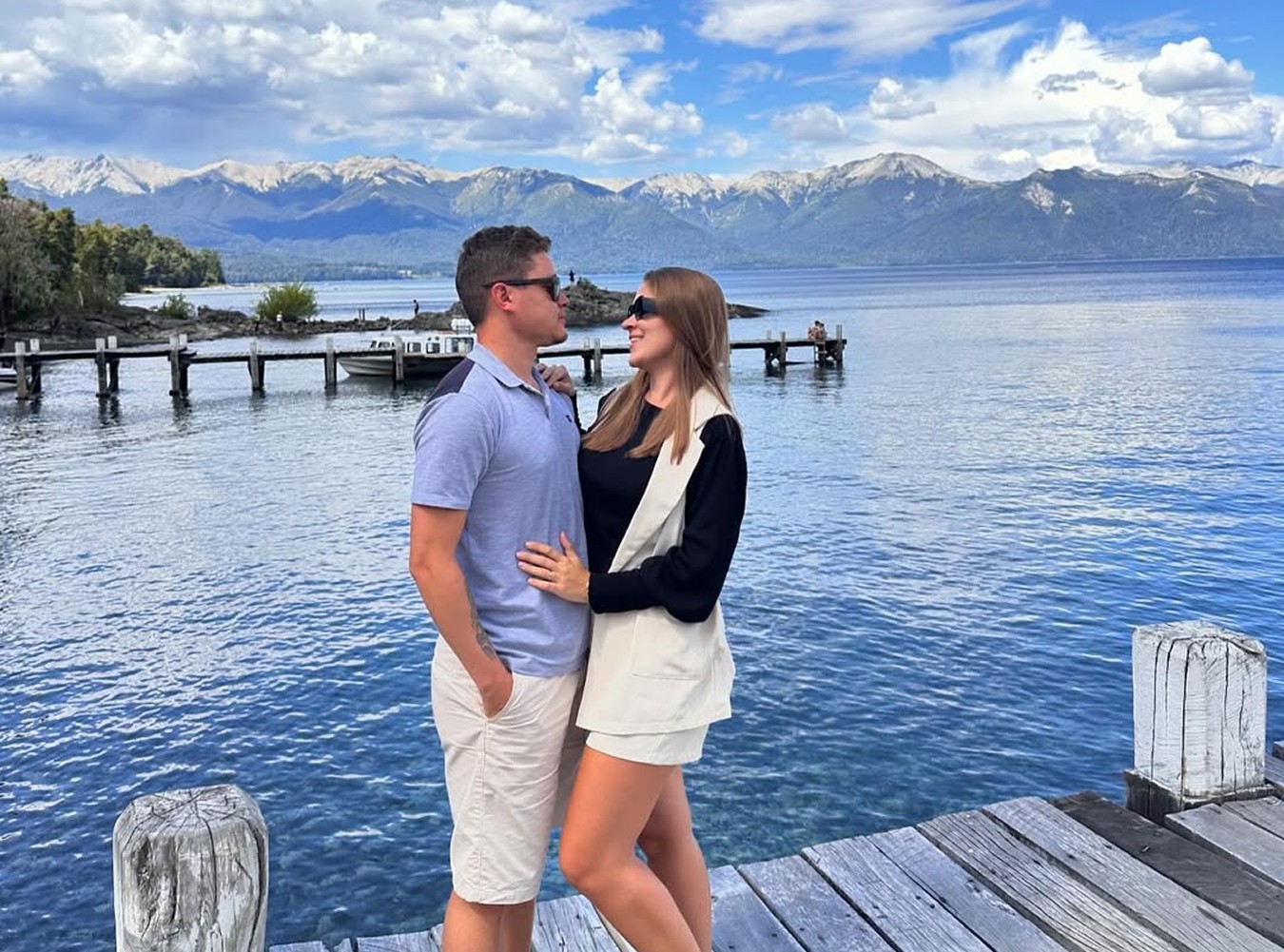 A man stading with Surfboard