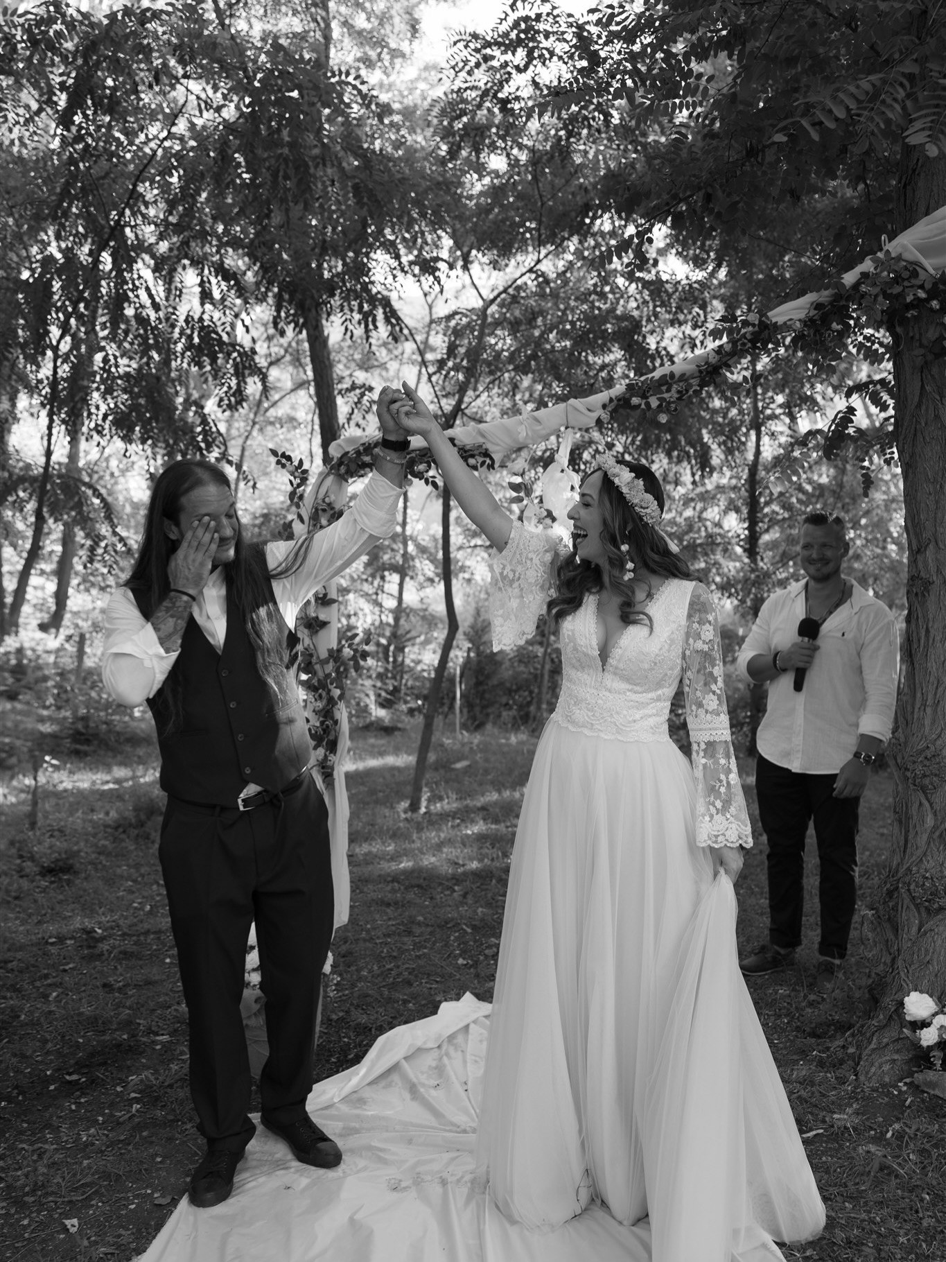 Bride and groom holding hands and groom is crying